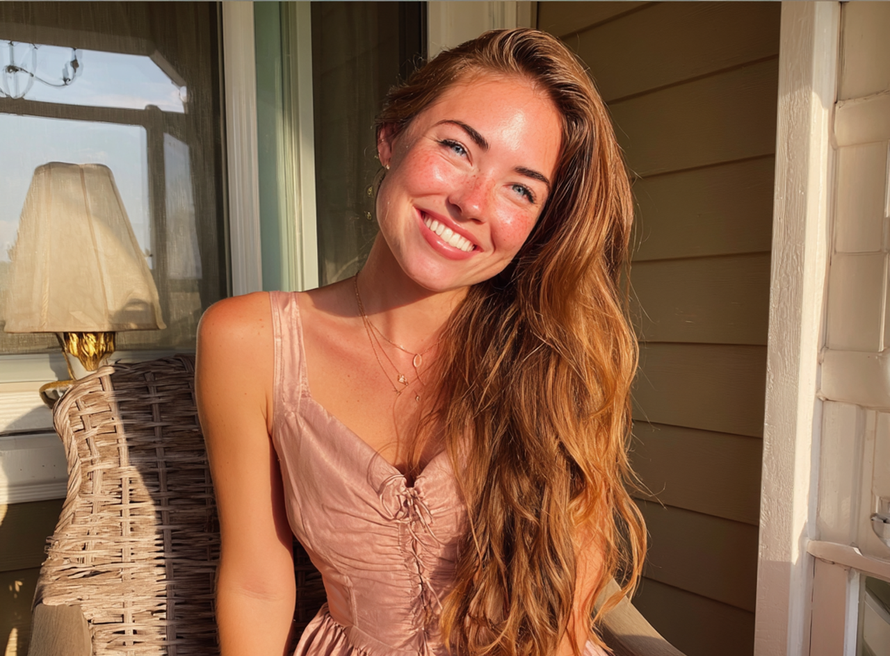 A smiling young woman wearing a pink dress | Source: Midjourney