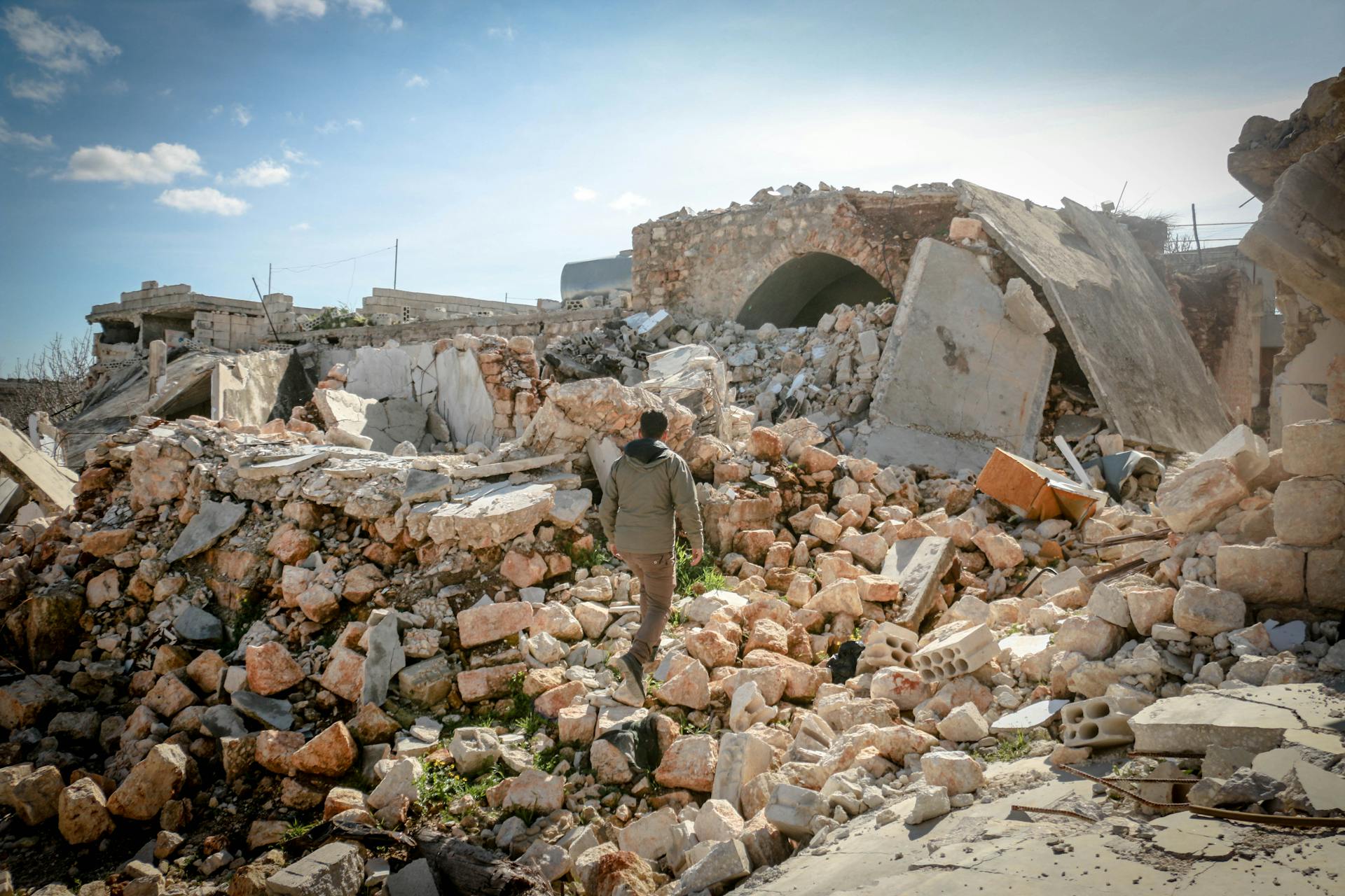 A man walking on the debris of a demolished site | Source: Pexels