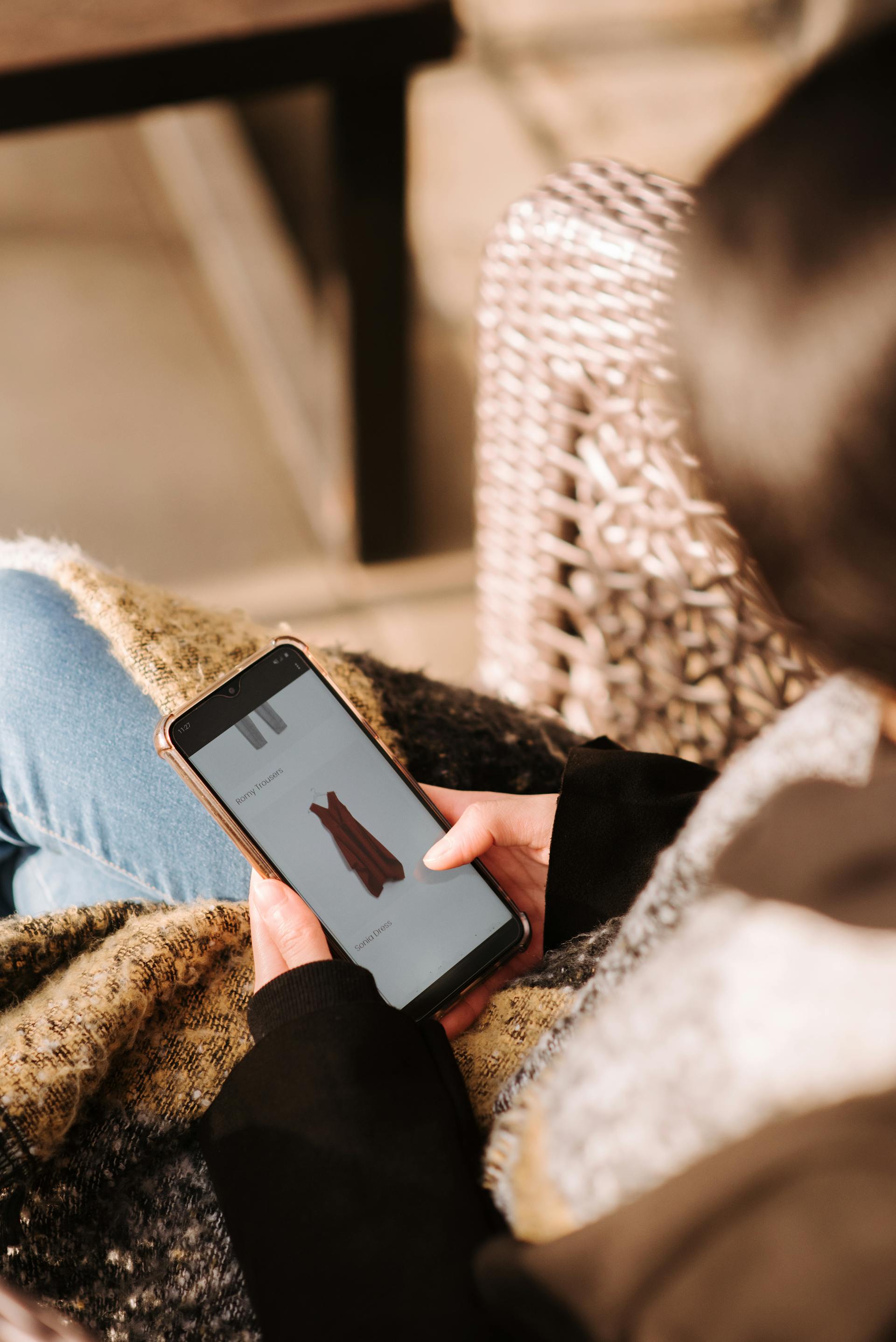 A woman scrolling on her phone | Source: Pexels