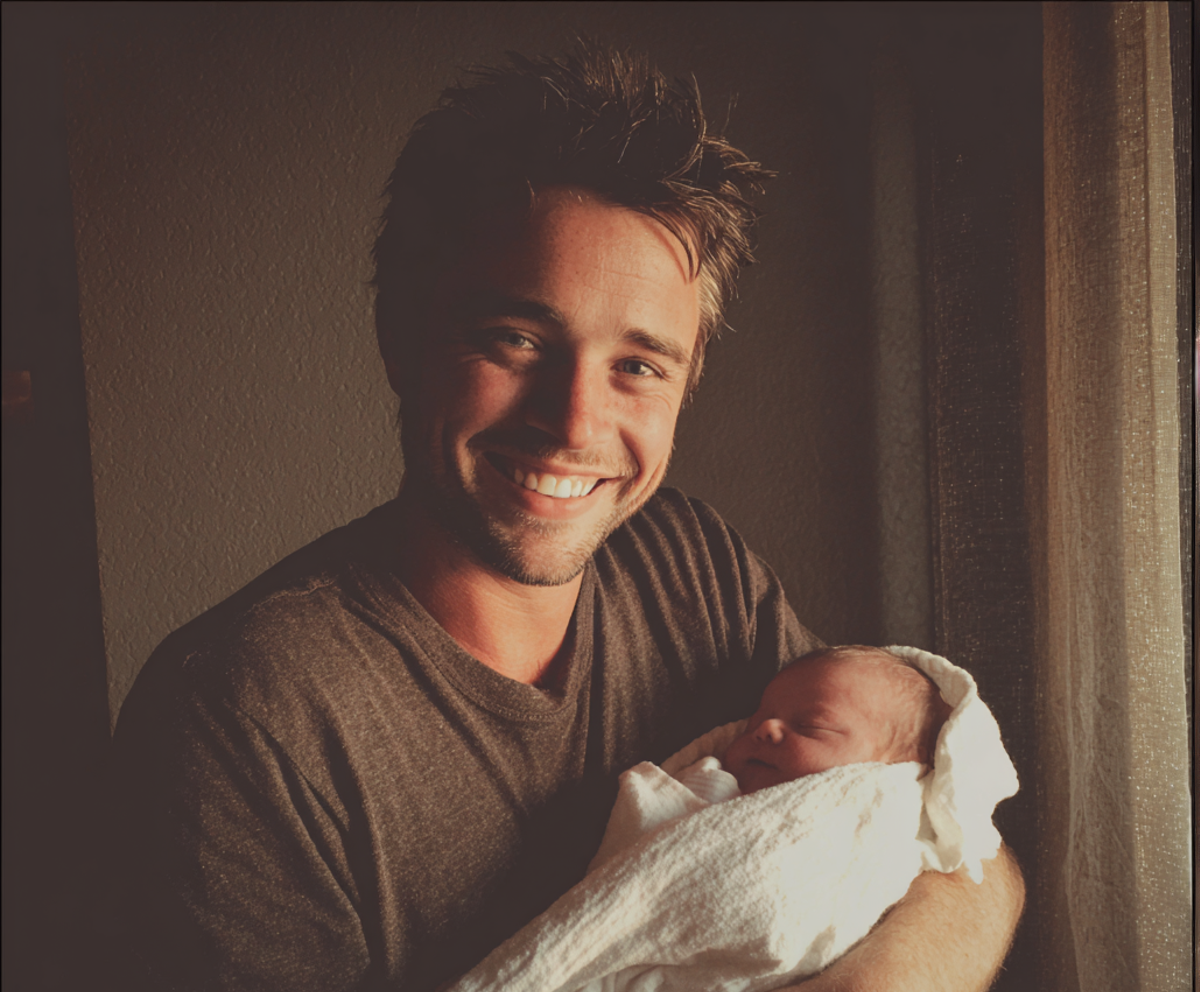 A man holding a newborn baby | Source: Midjourney