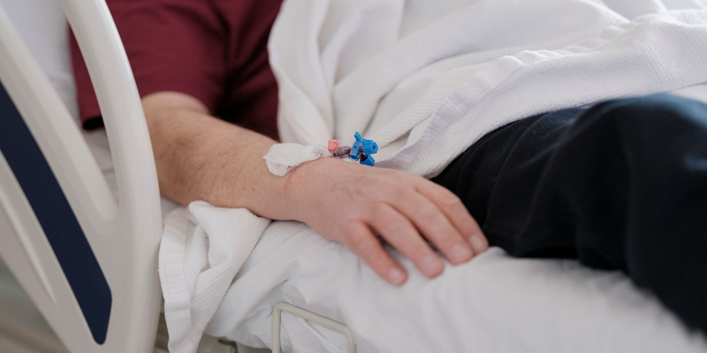 Patient resting in a hospital bed with an IV | Source: Pexels