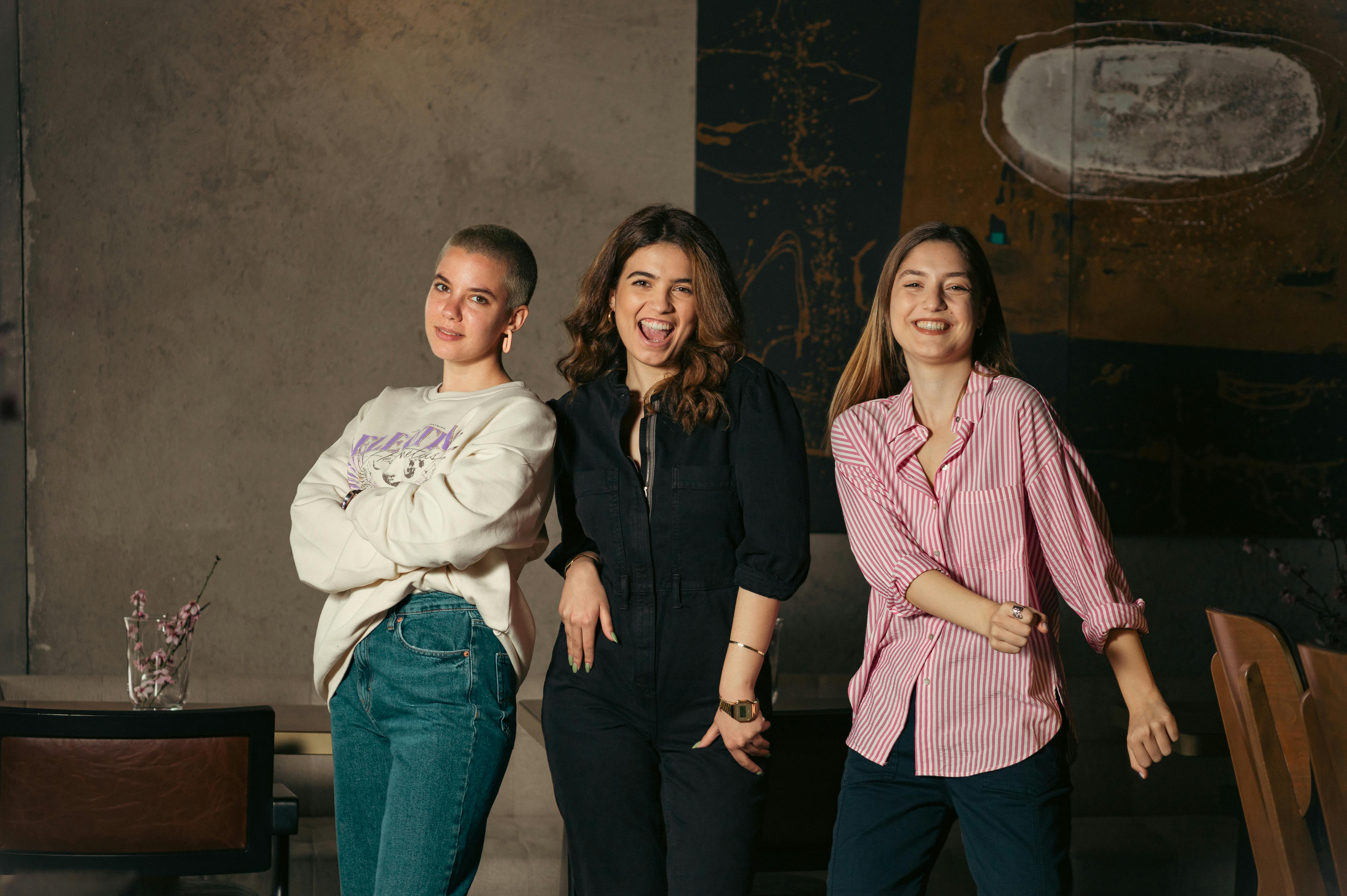 A group of three young women smiling sweetly | Source: Pexels