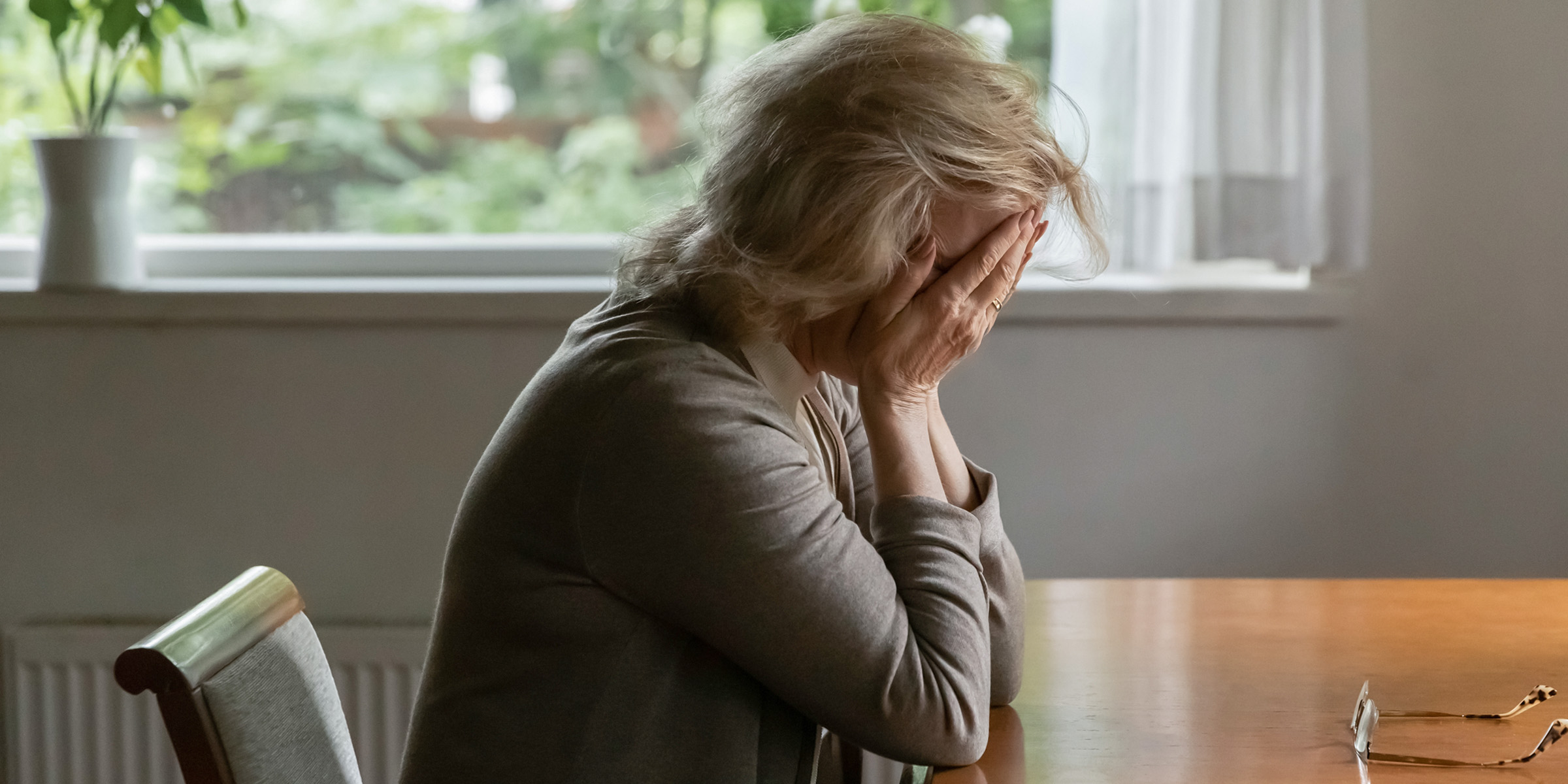 An elderly woman crying | Source: Shutterstock