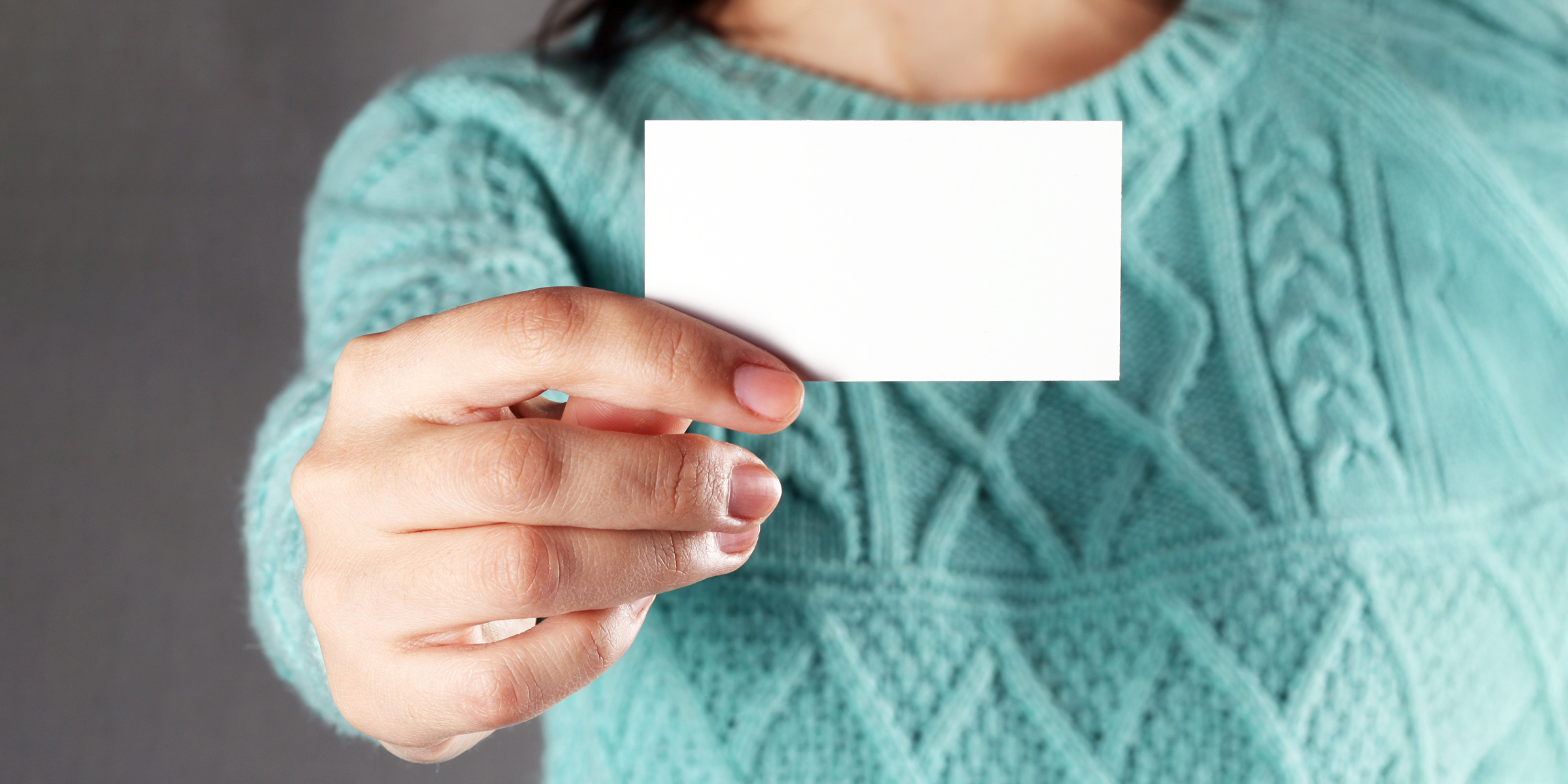 A woman holding a piece of paper | Source: Shutterstock