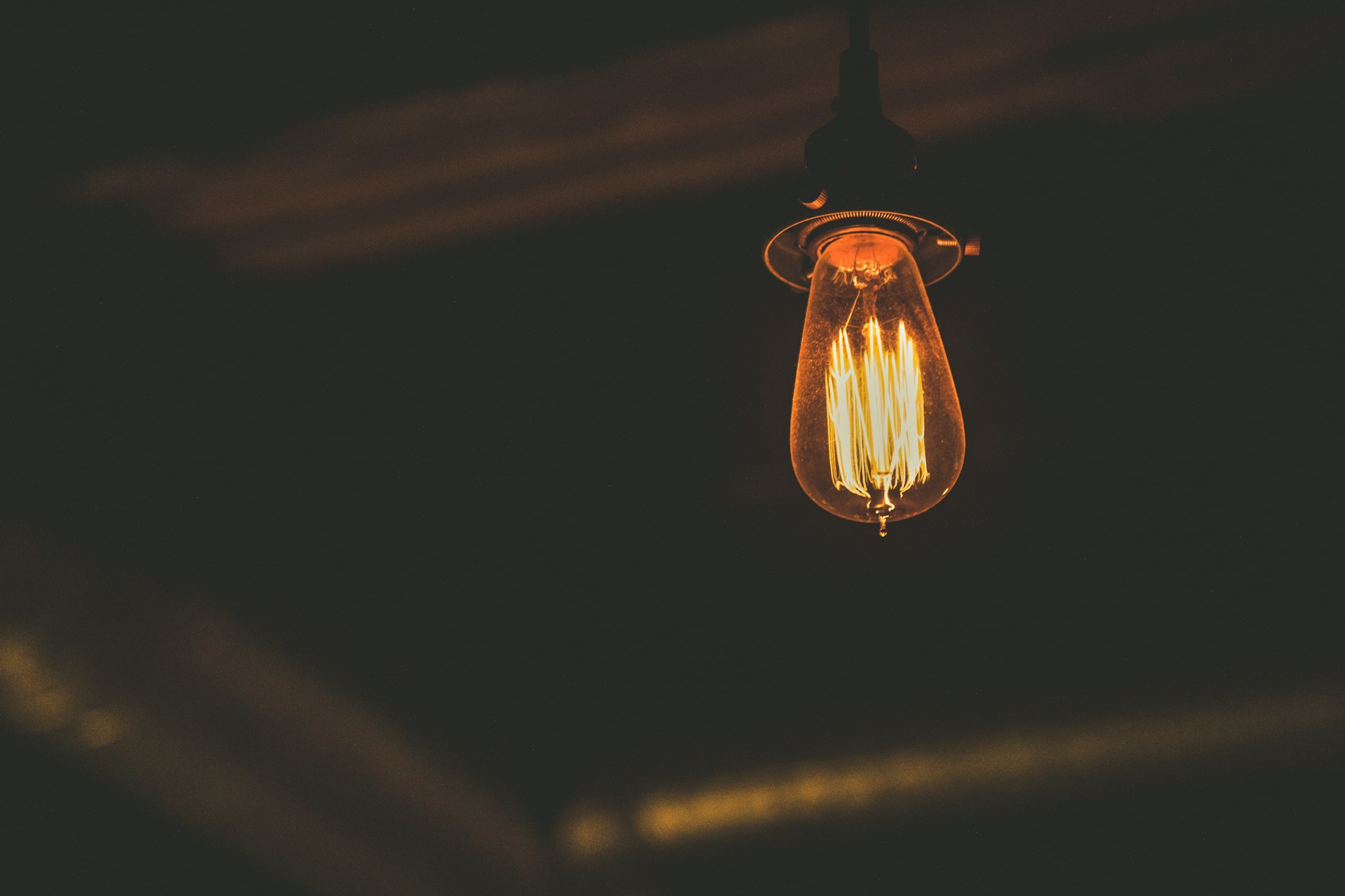 A lightbulb hanging from the ceiling of a room | Source: Unsplash