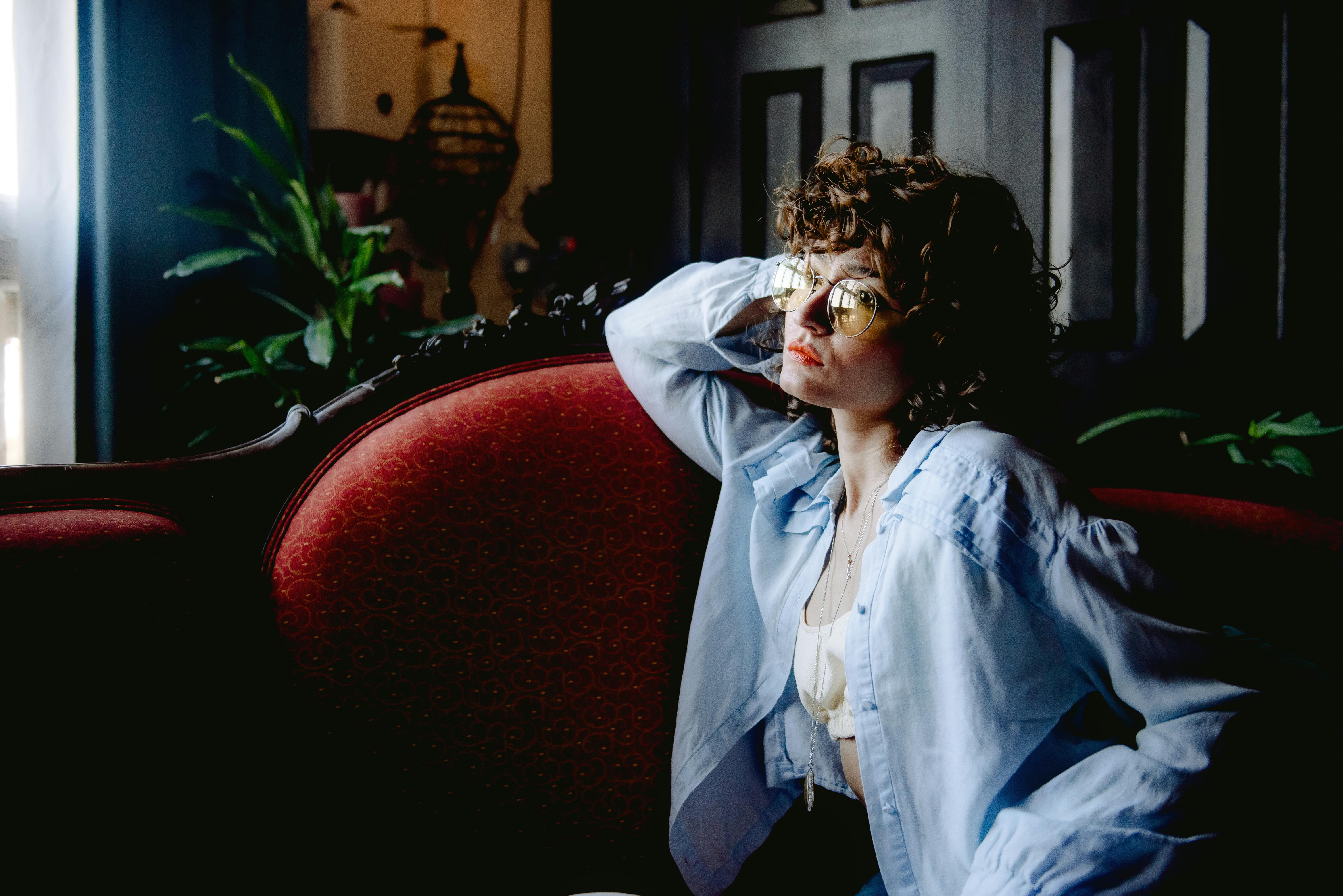 A woman sitting on a couch | Source: Pexels