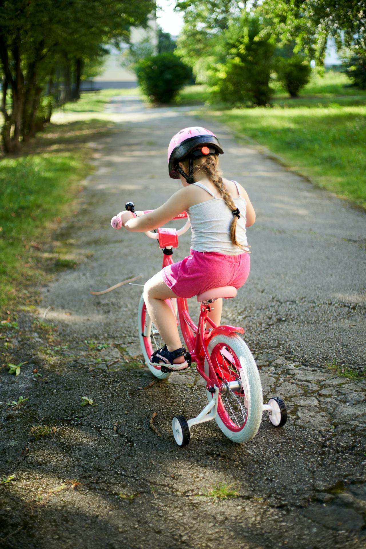 A little girl riding her bike | Source: Pexels