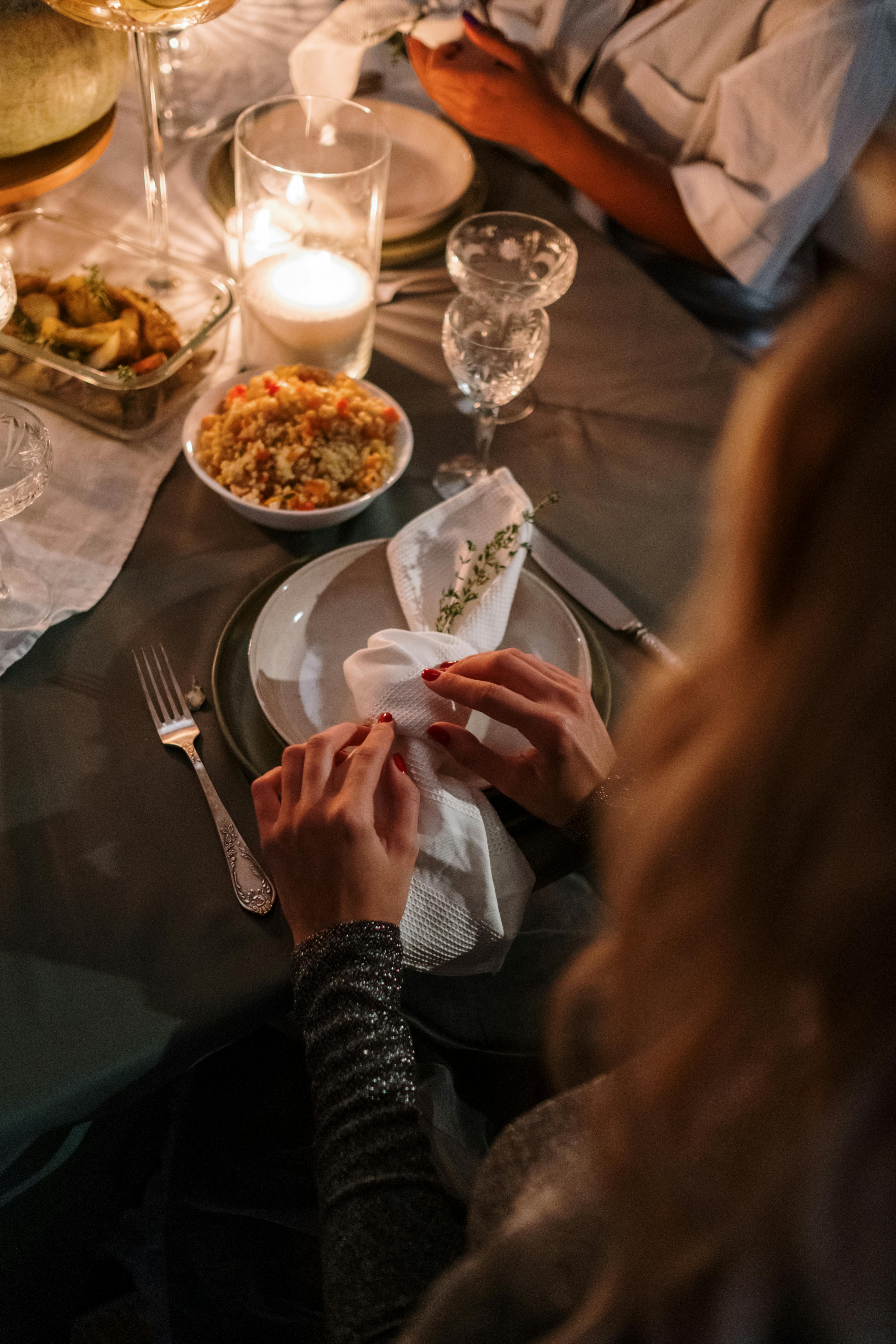 A woman sitting at a dinner table | Source: Pexels