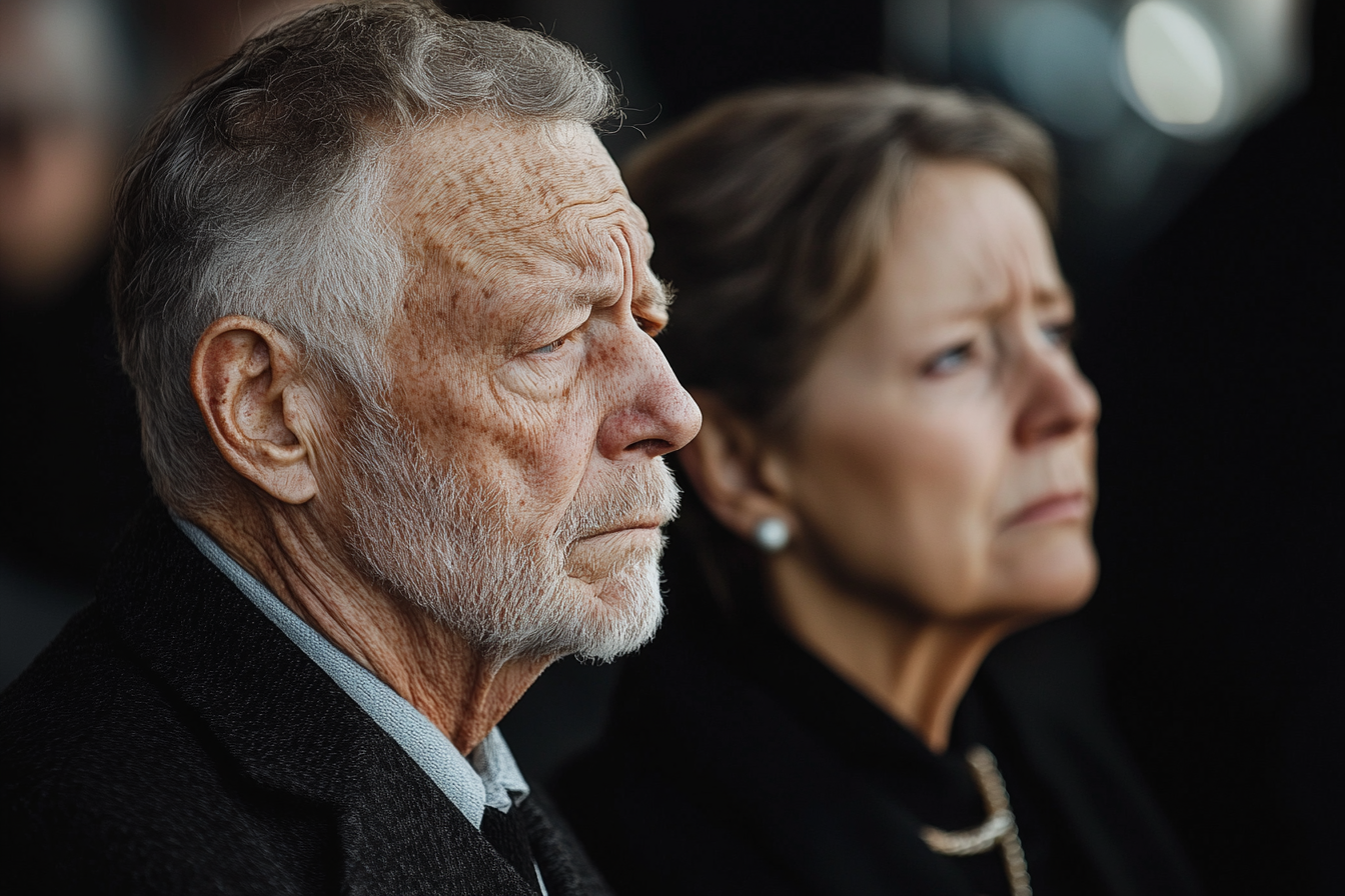 A mature couple at a funeral reception | Source: Midjourney