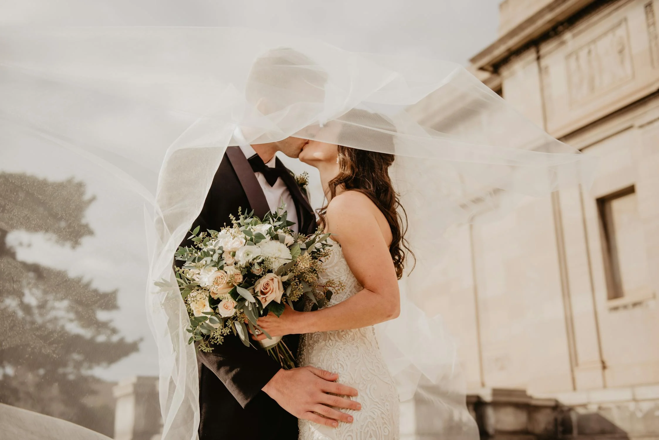 A groom and a bride kissing | Source: Pexels