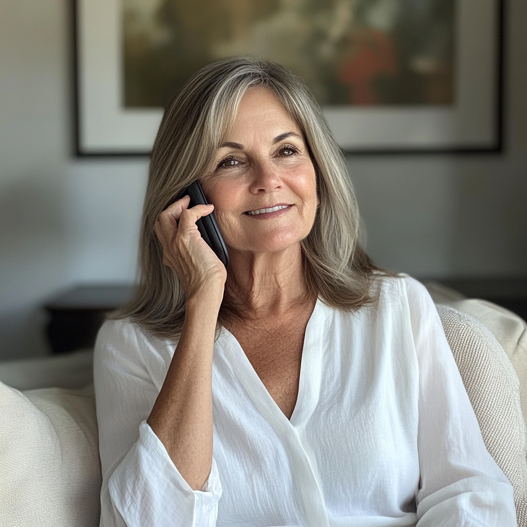 A smiling woman talking on a phone | Source: Midjourney