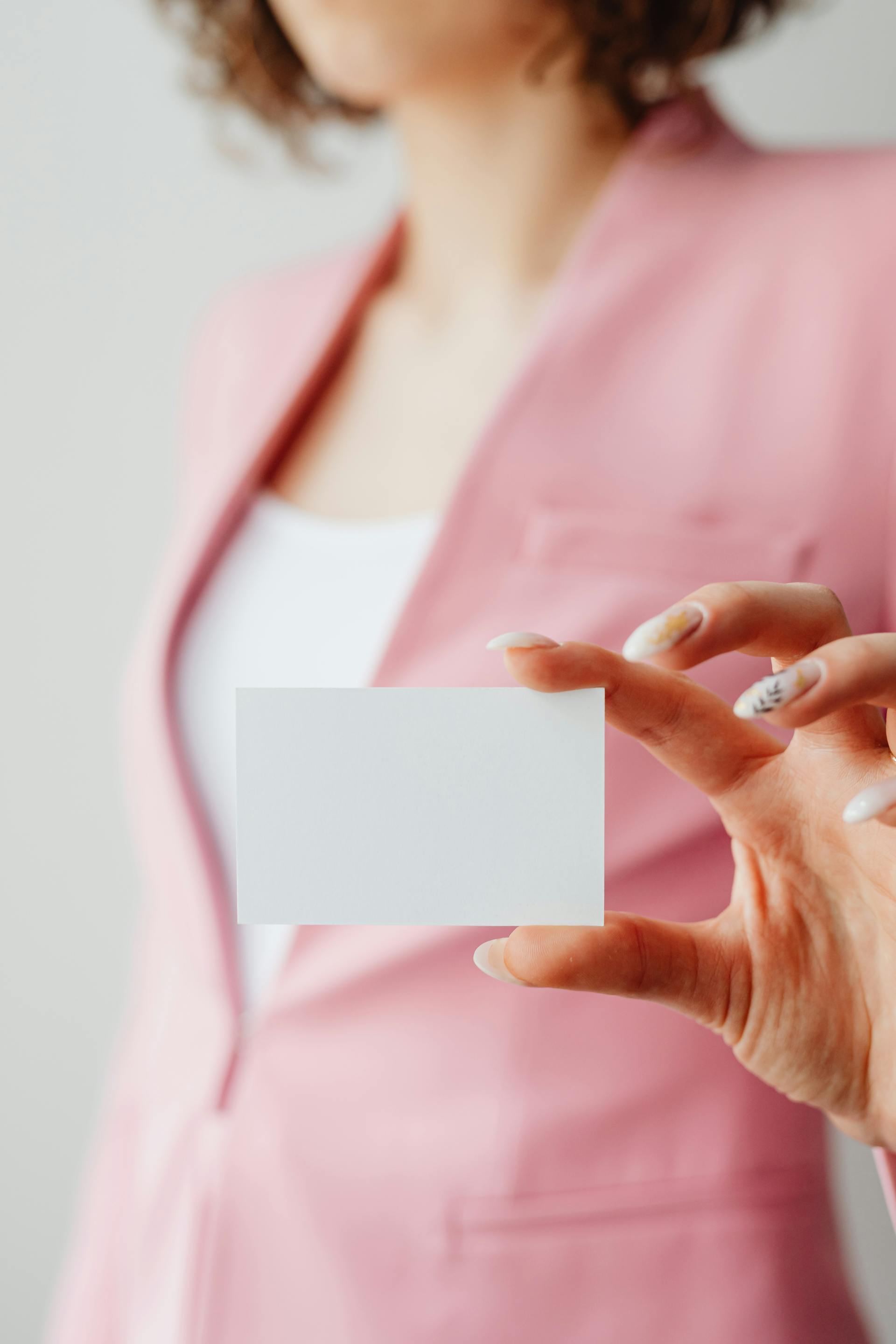 A woman holding a card | Source: Pexels