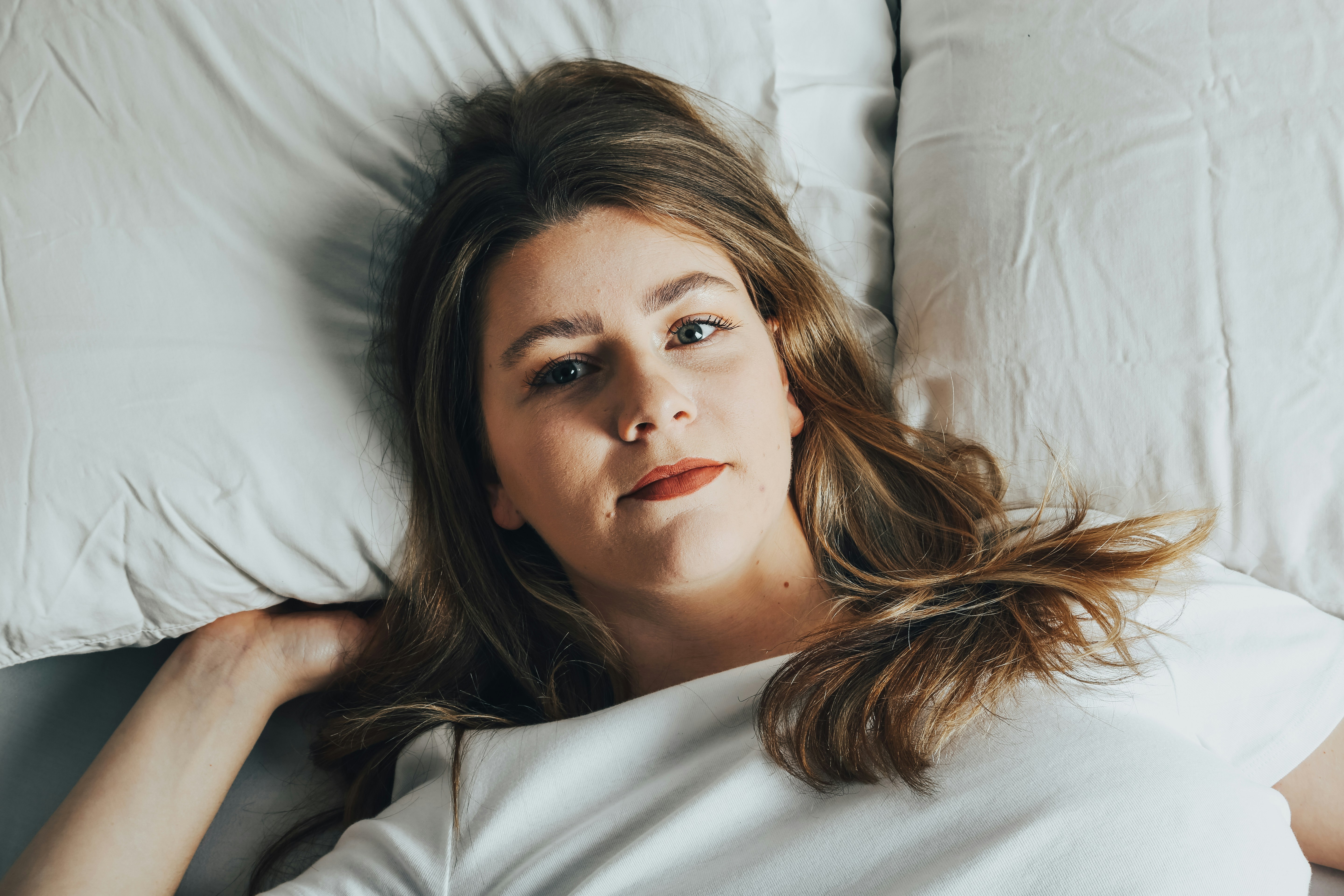 A teenage girl lying in bed | Source: Unsplash