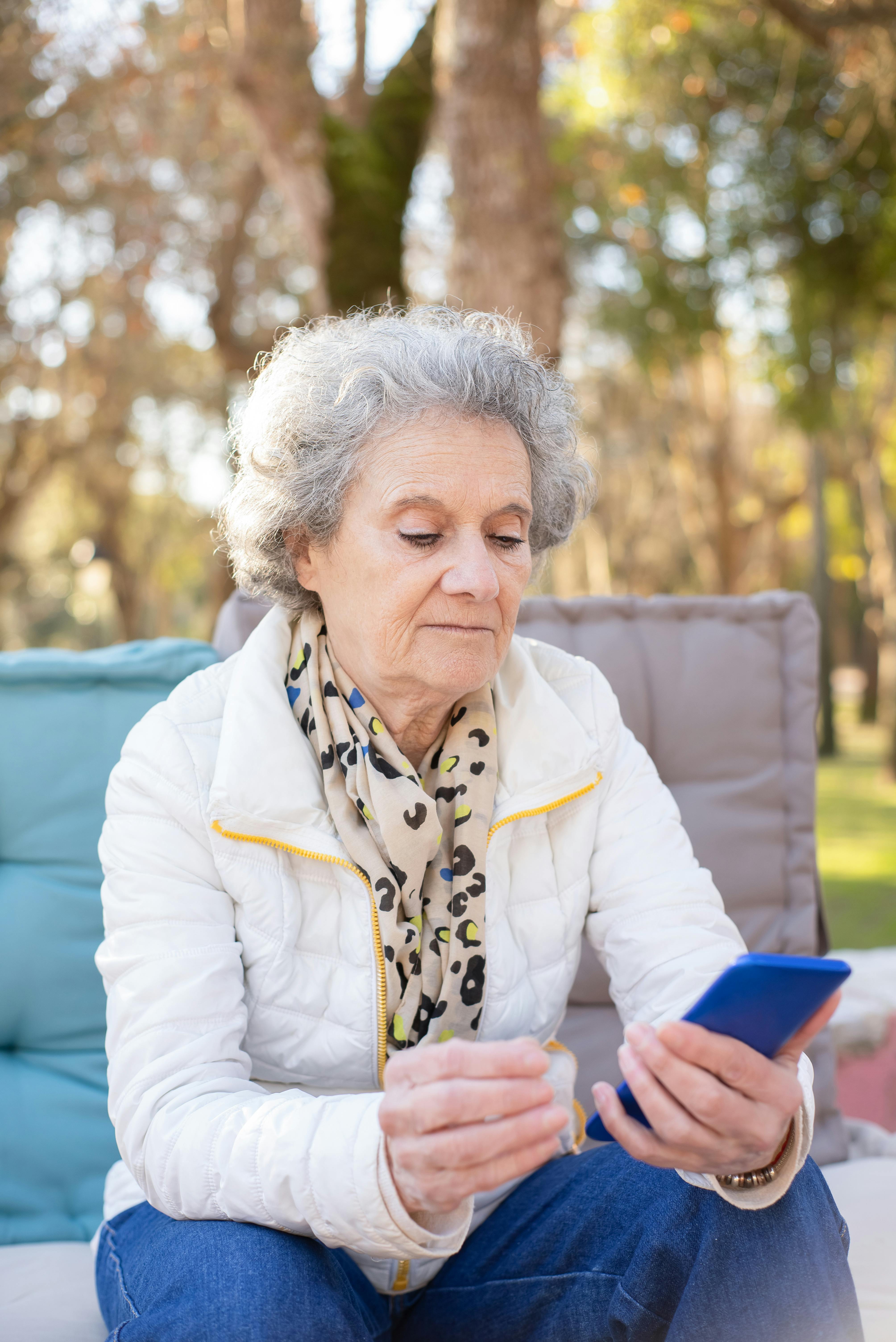 A serious woman looking at her phone | Source: Pexels
