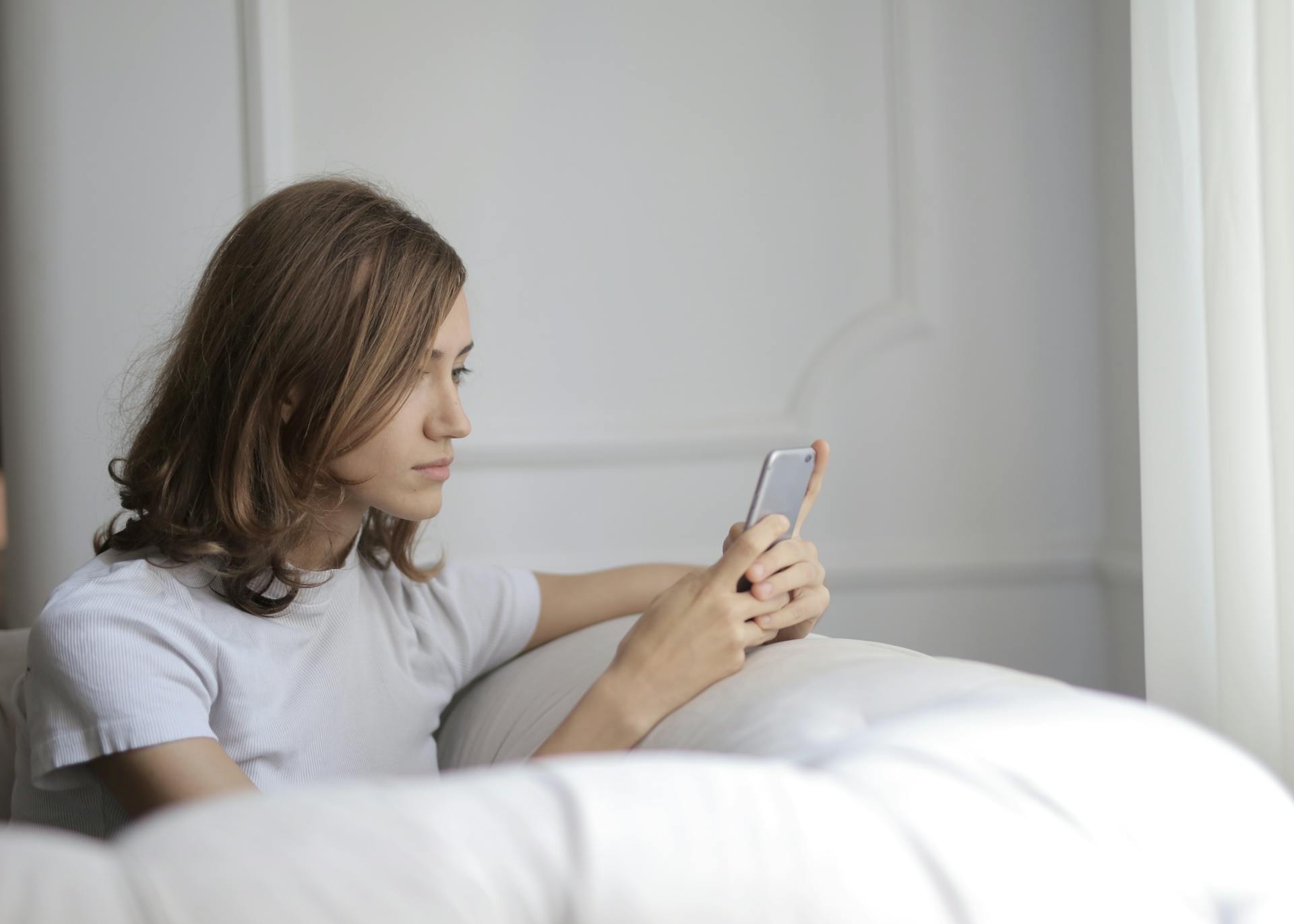 A woman looking at her phone screen | Source: Pexels