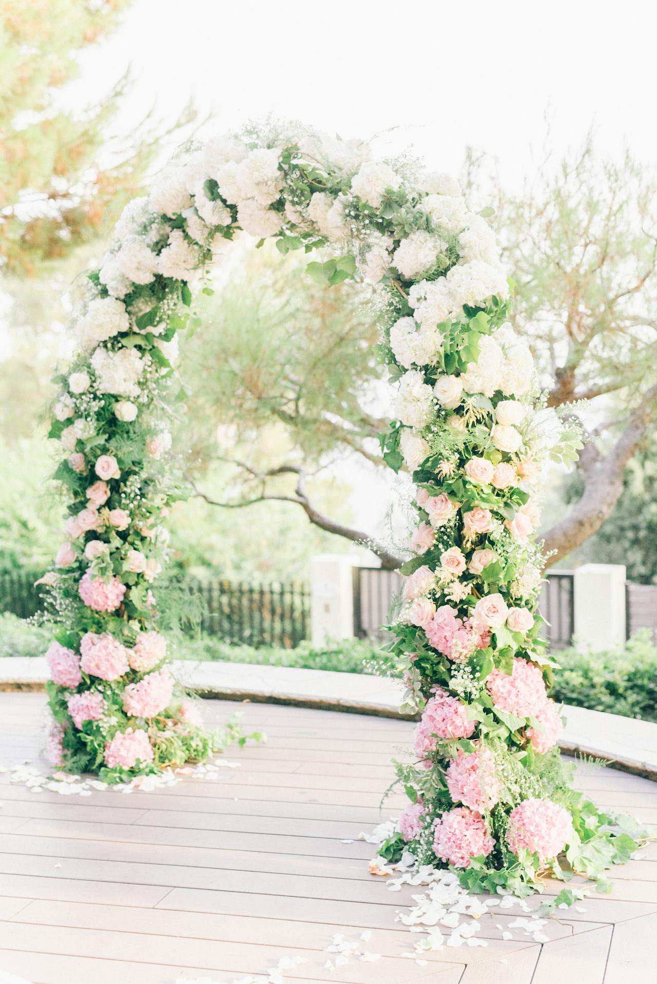 A wedding arch with pink and white blooming flowers | Source: Pexels