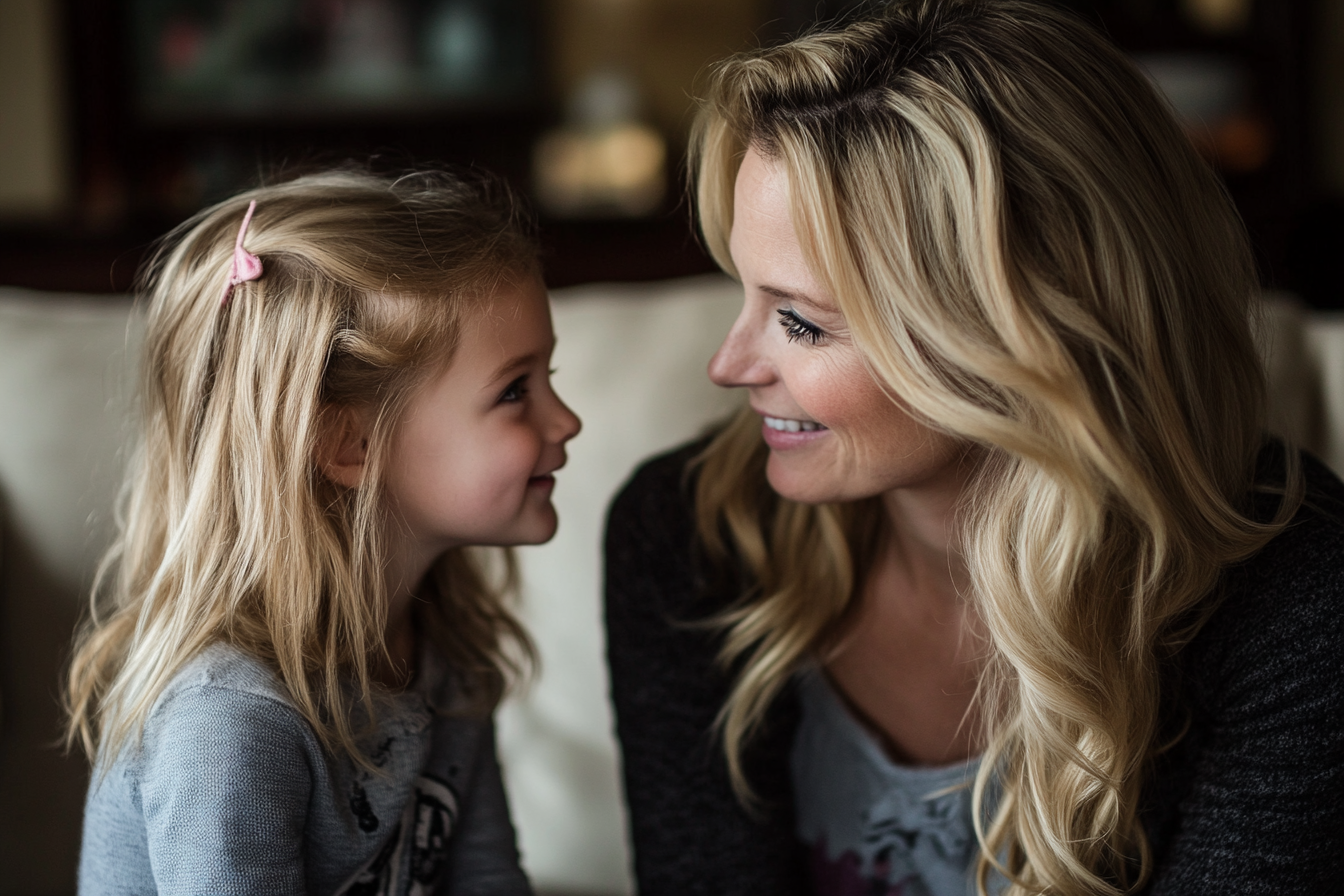 Una mujer sonriéndole a su hija | Fuente: Midjourney