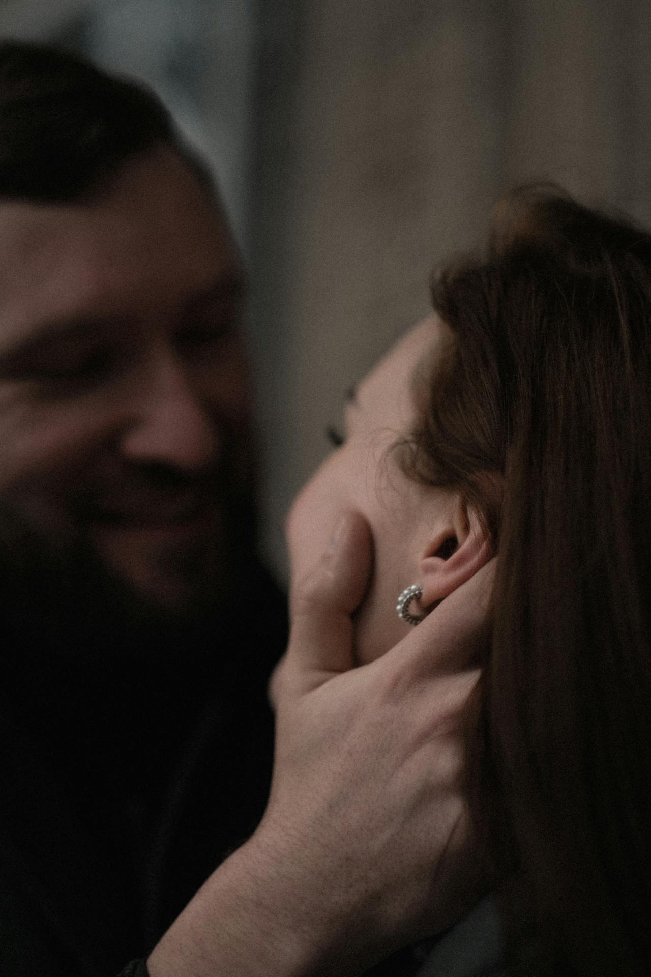 A smiling man holding a woman close | Source: Pexels
