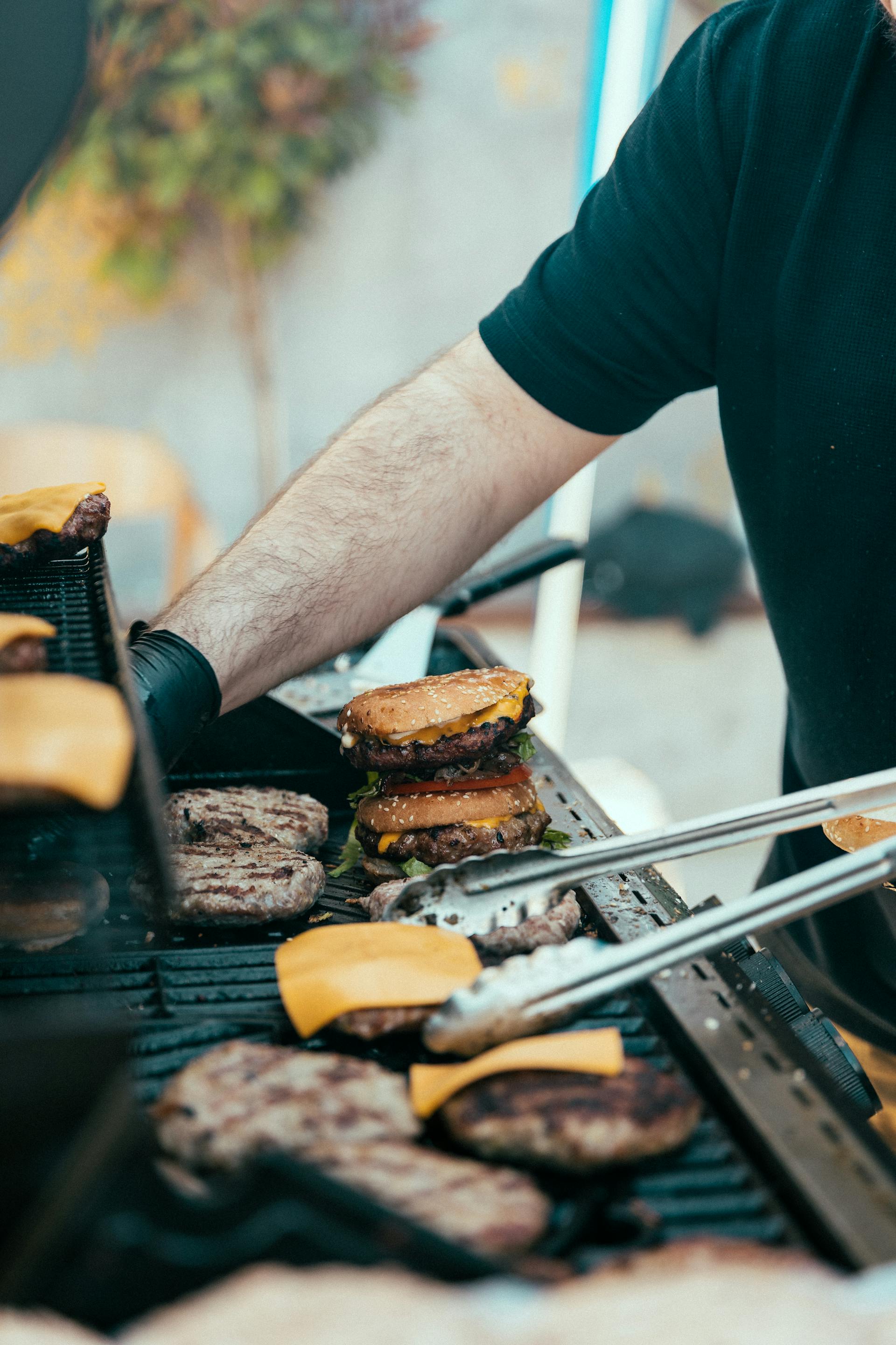 A close-up shot of a man grilling burgers | Source: Pexels