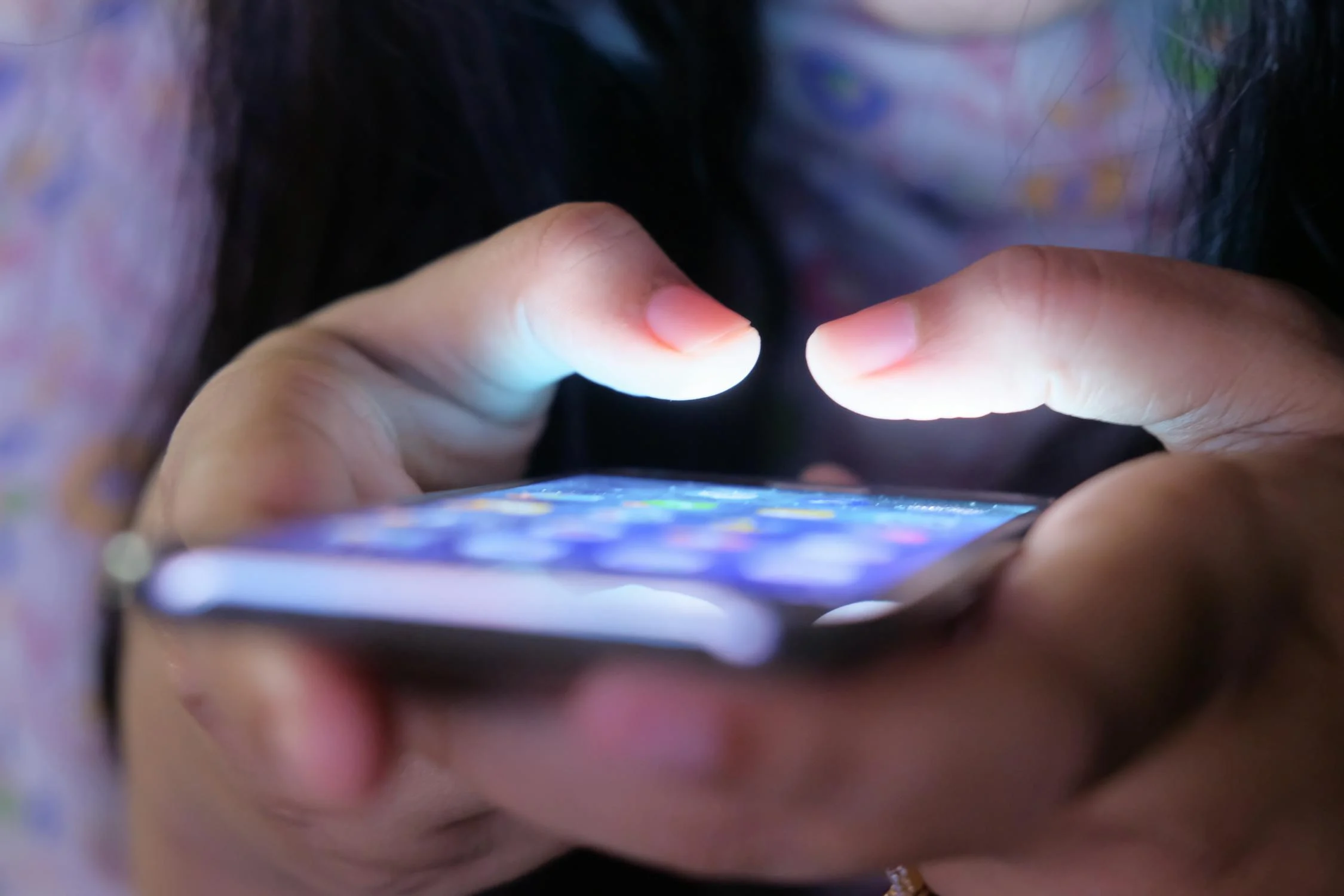 A woman looking through a phone at night | Source: Pexels