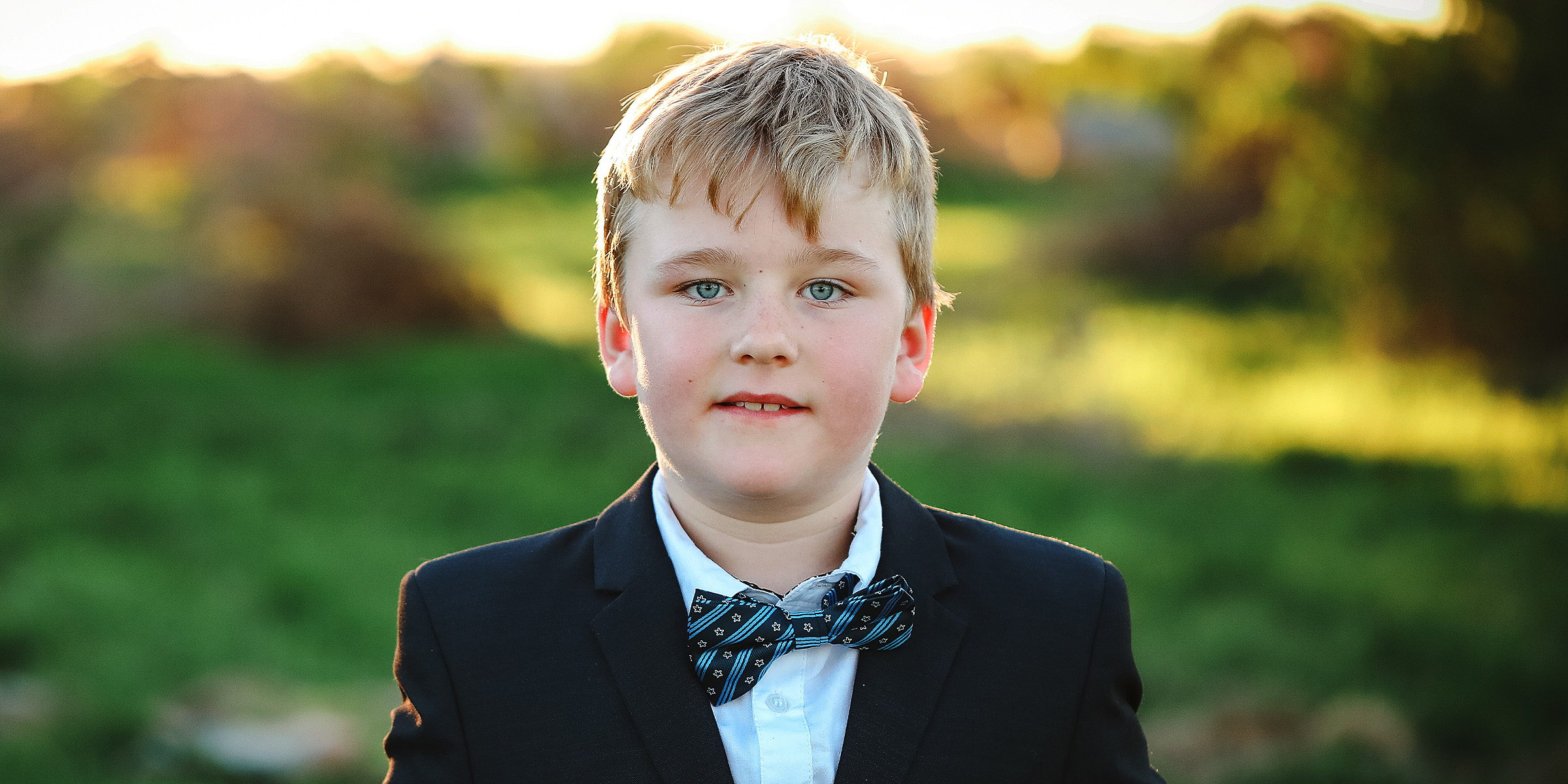 A little boy wearing a suit | Source: Freepik