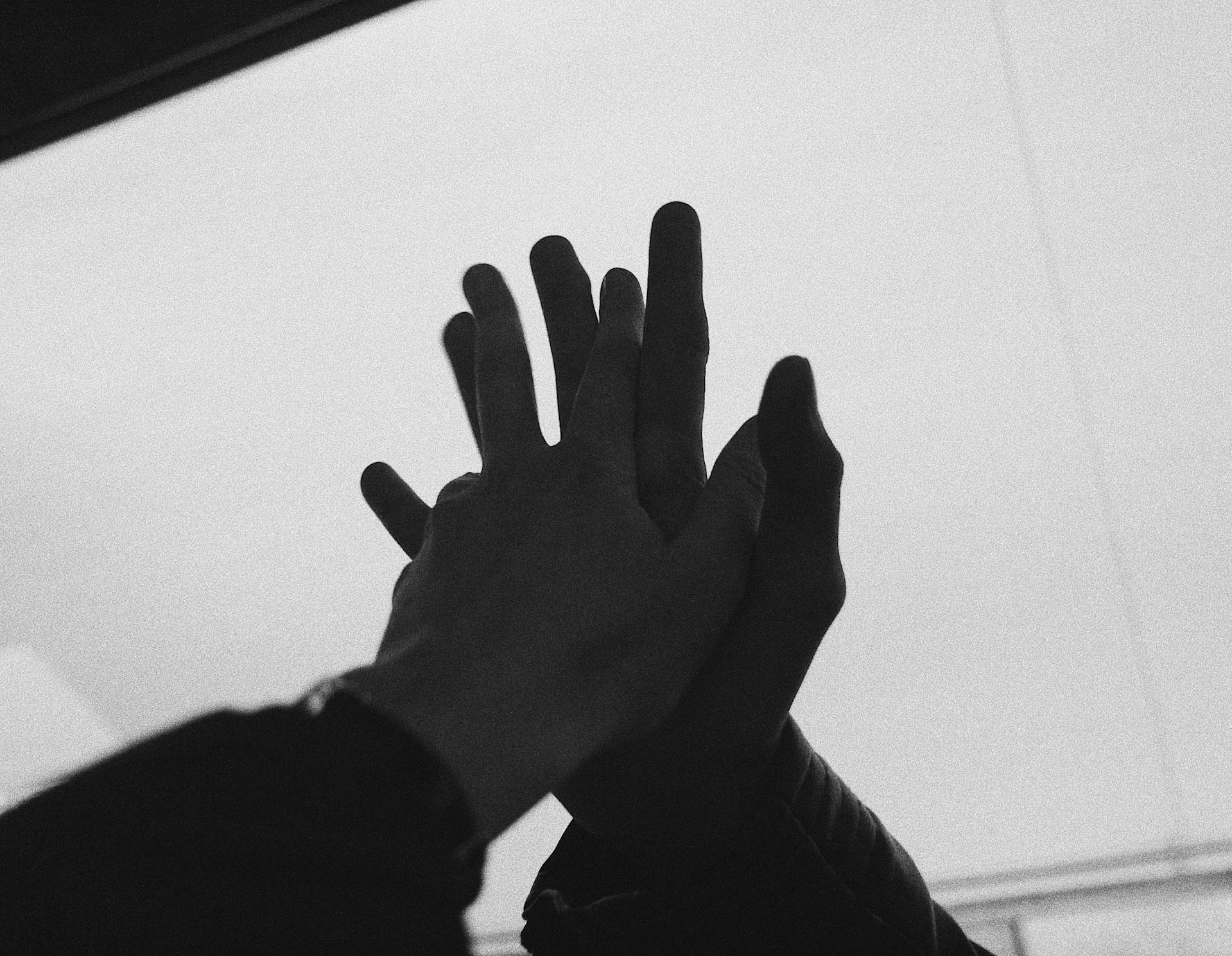 Two people giving each other a hi-five | Source: Pexels