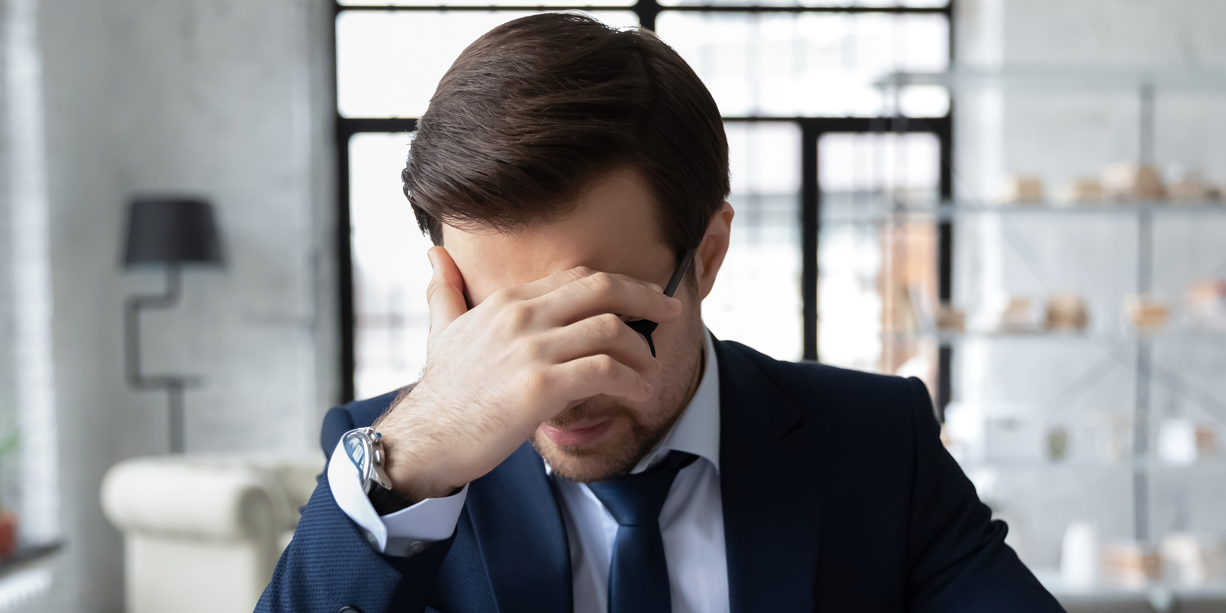 A man resting his head in one hand | Source: Shutterstock