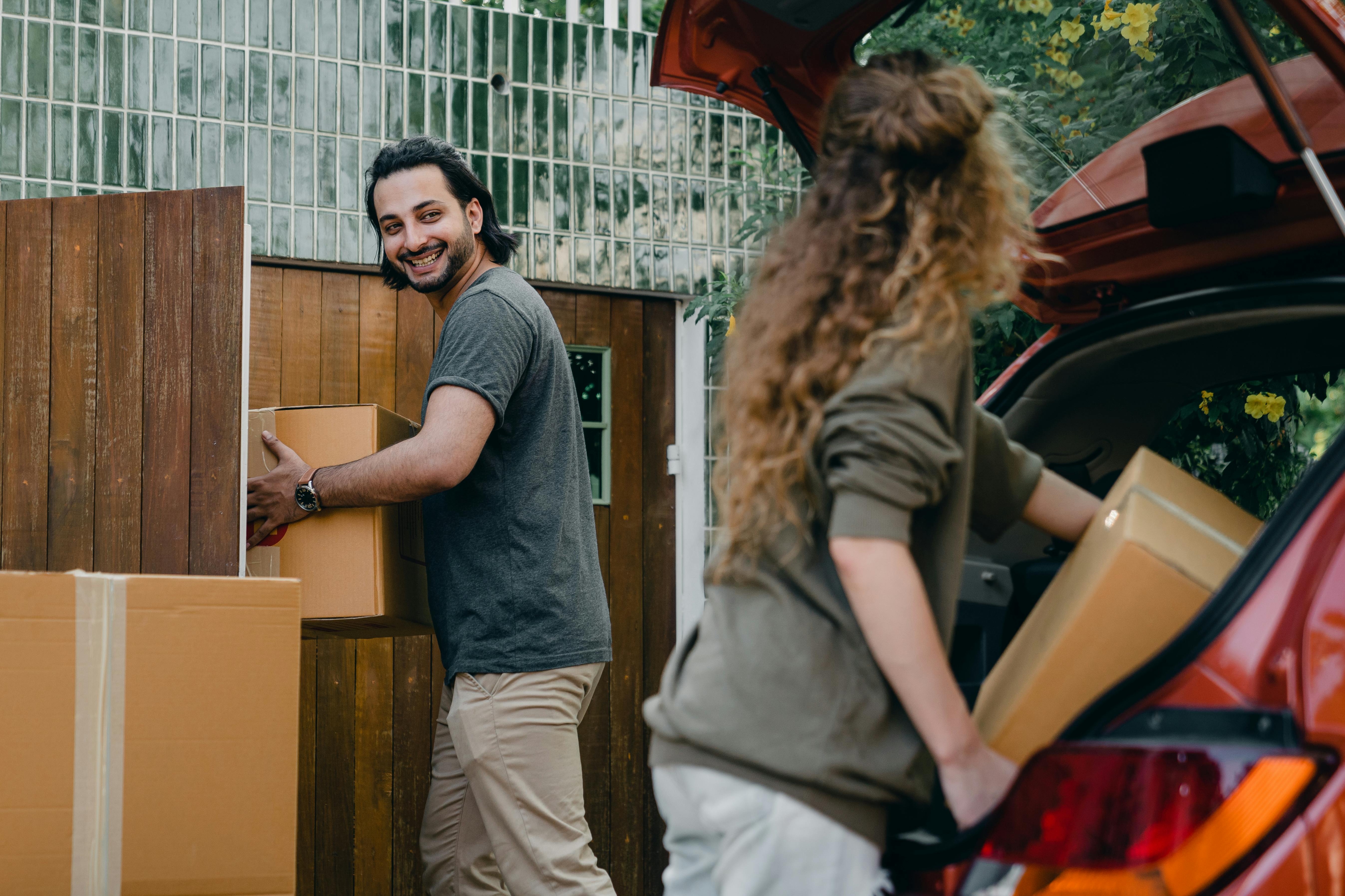 A couple unloaded boxes from a car | Source: Pexels