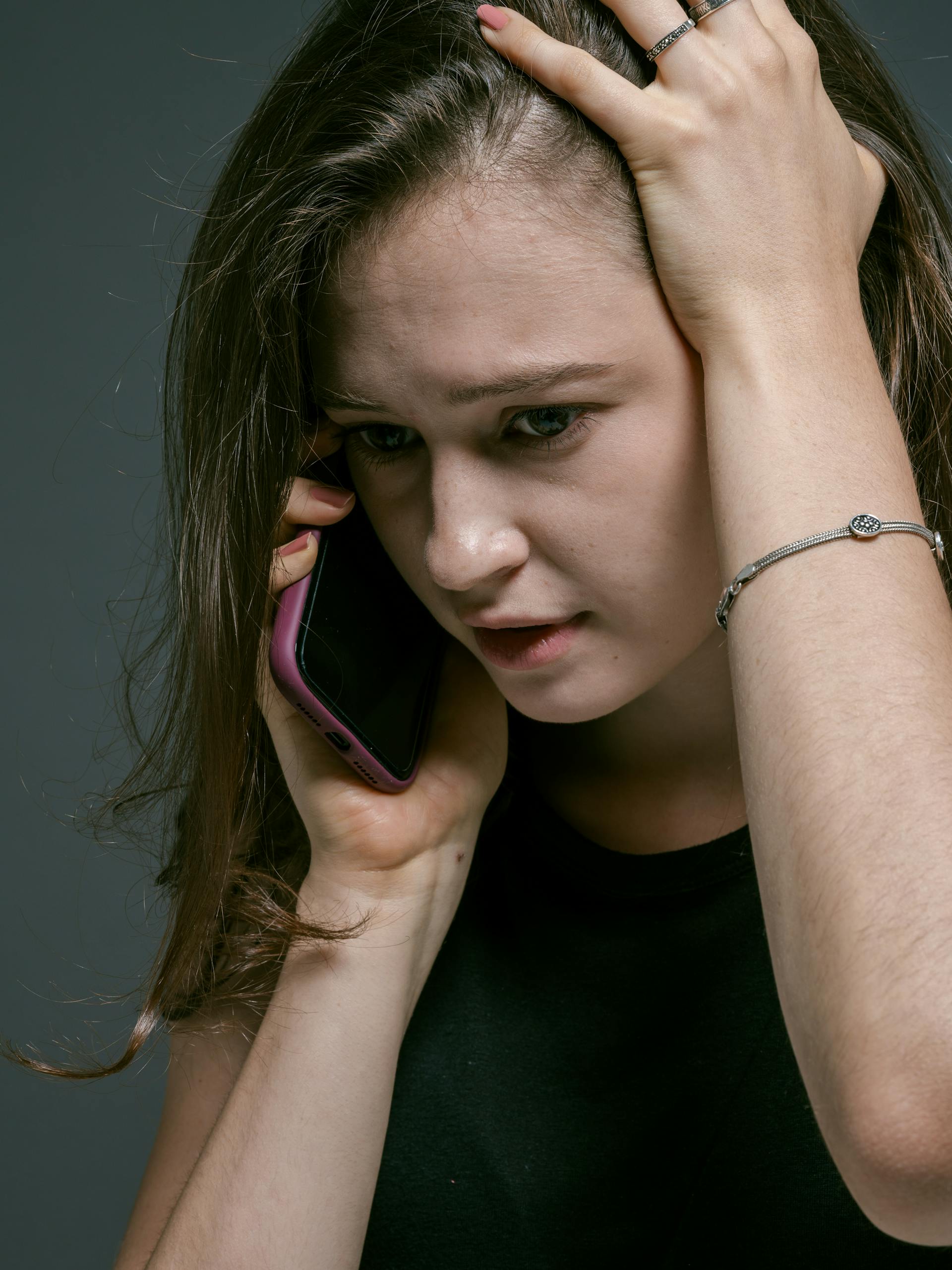 A tense woman speaking on her phone | Source: Pexels