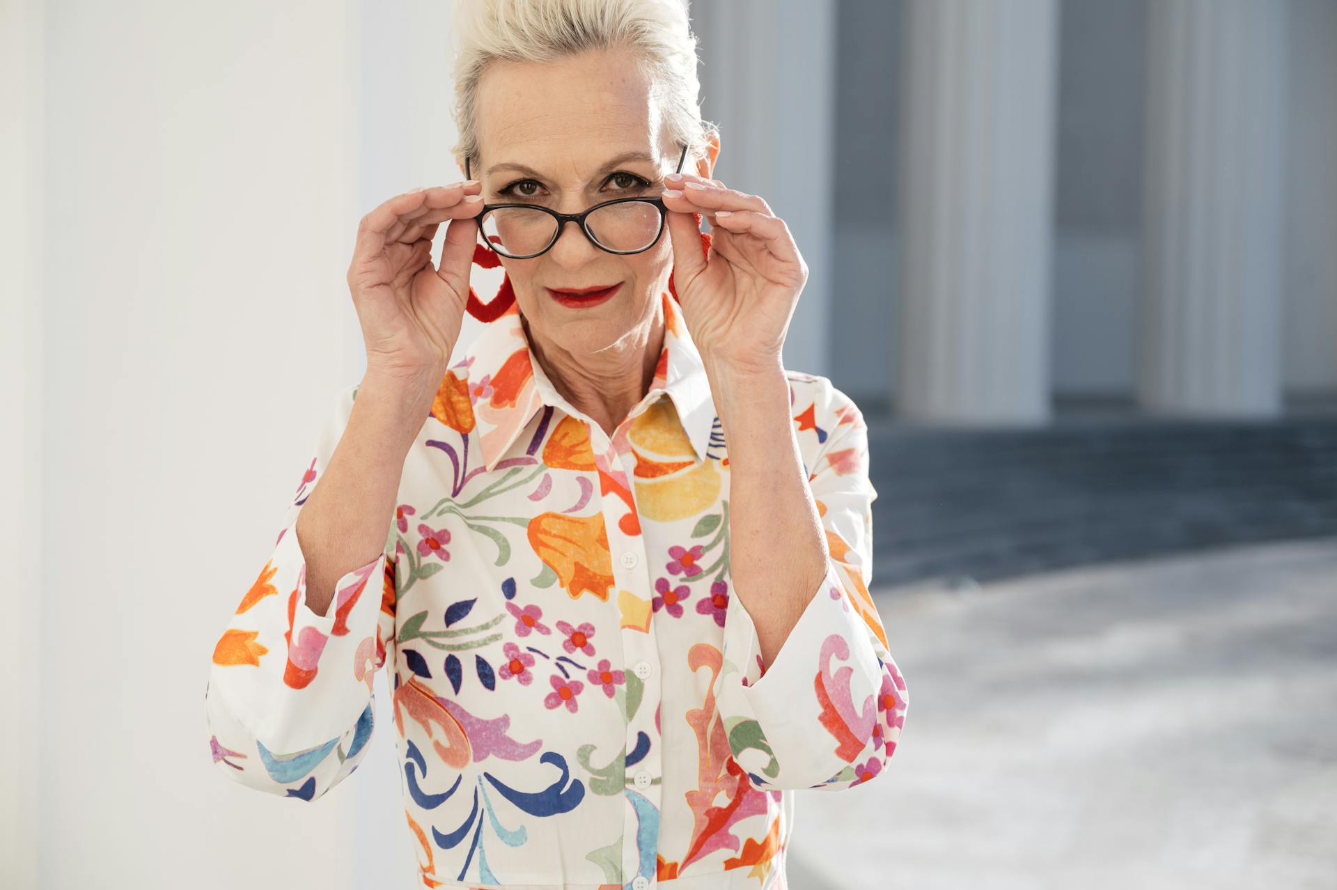 A senior woman holding her glasses | Source: Pexels