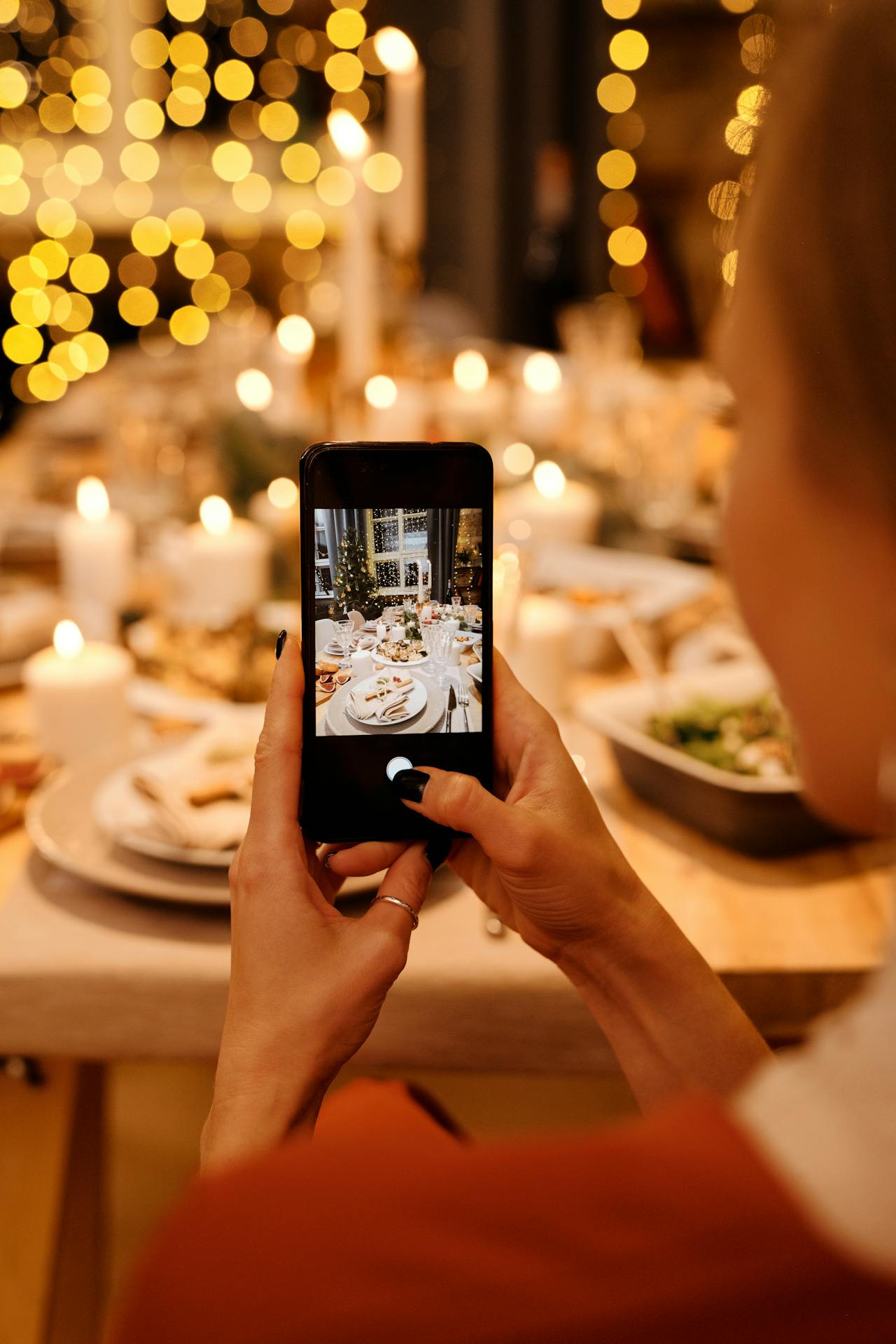 A woman taking a photo of food on the table | Source: Pexels