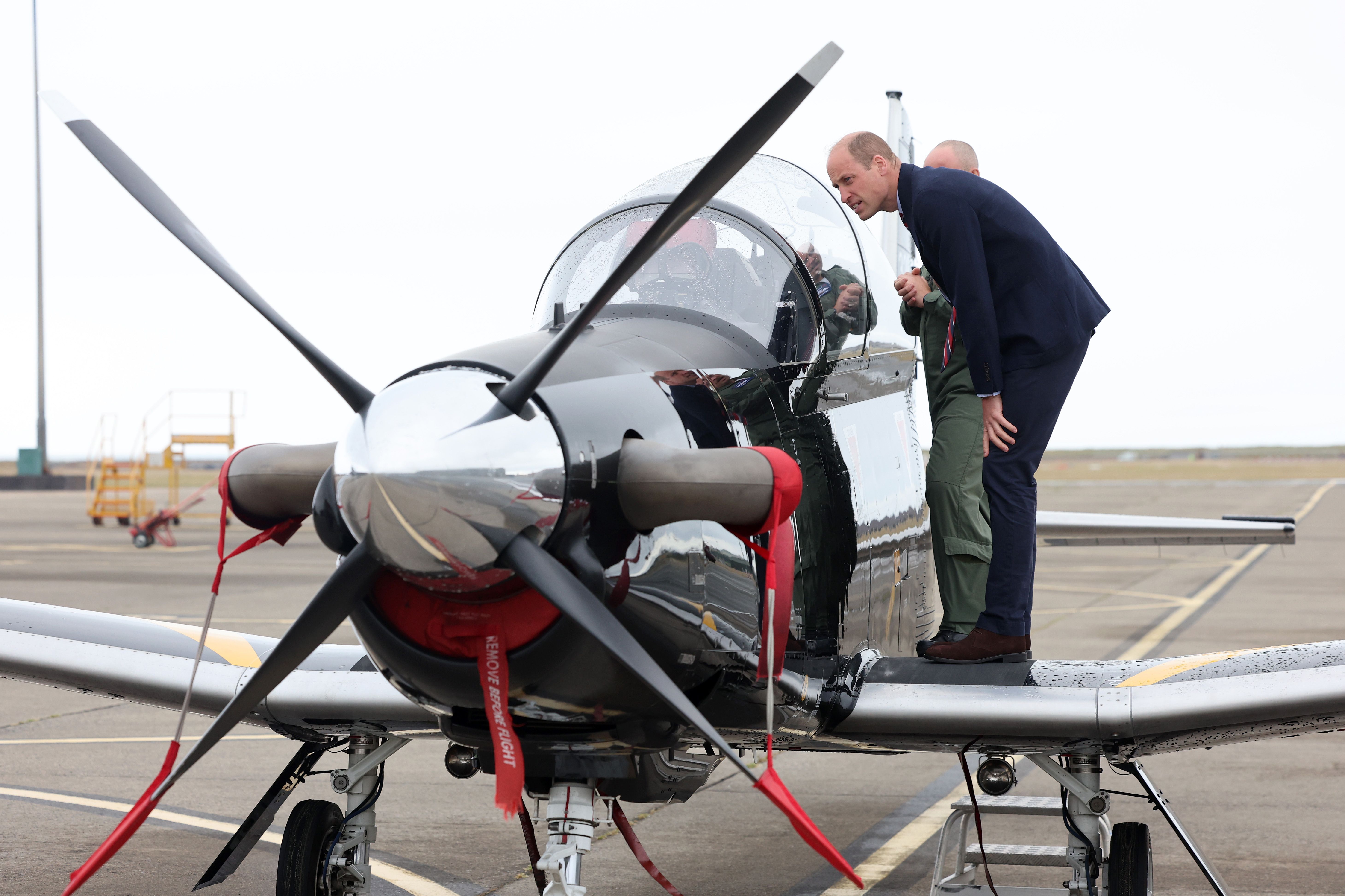 Prince William, Prince of Wales gets an introduction to a RAF Short Tucano trainer aircraft during an official visit at RAF Valley in Holyhead, United Kingdom, on July 9, 2024 | Source: Getty Images