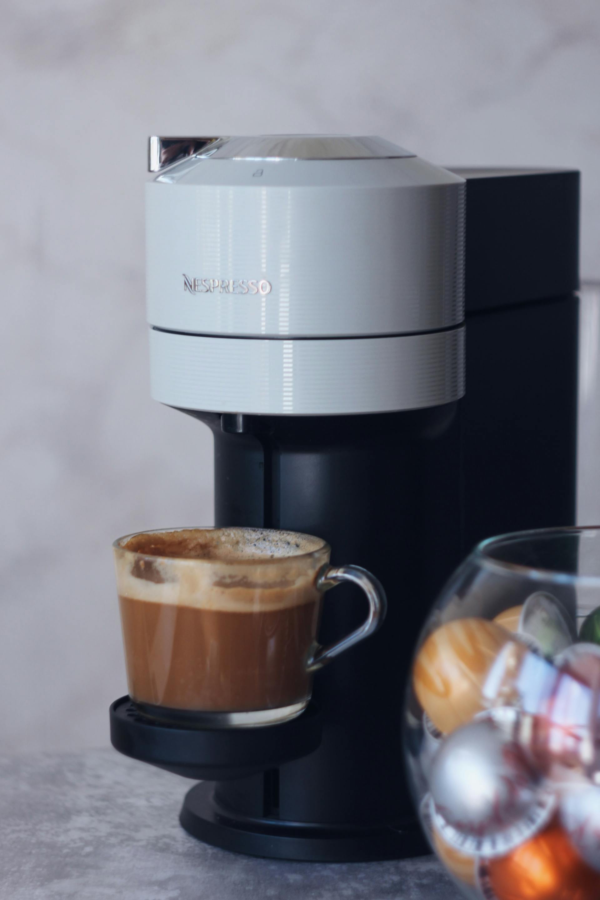 A full cup of coffee in a coffee machine | Source: Pexels