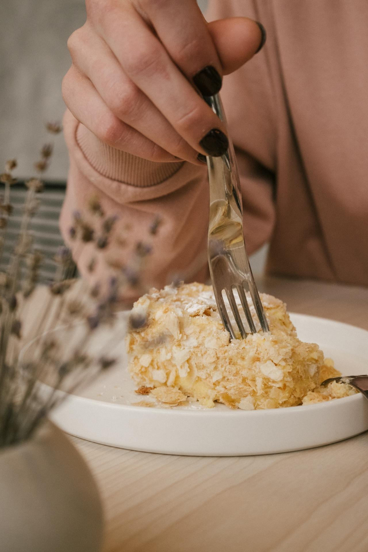 A woman eating a pastry | Source: Pexels