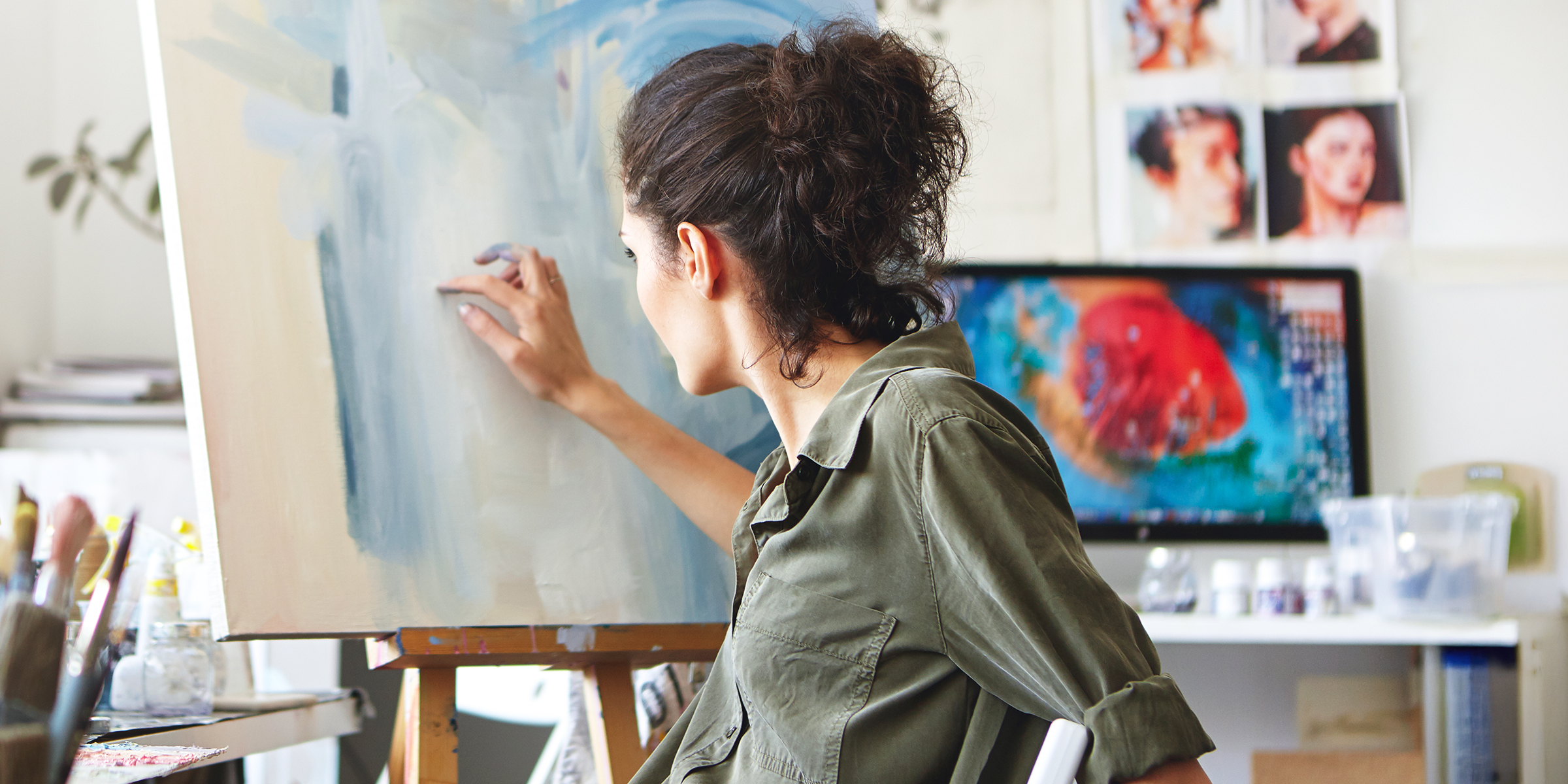 A woman painting a picture on a canvas | Source: Shutterstock