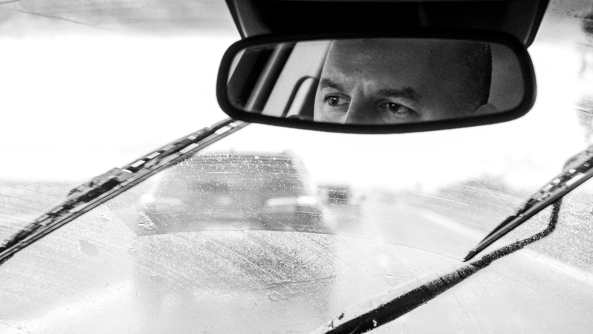 Reflection of a man's eyes in the rearview mirror | Source: Pexels