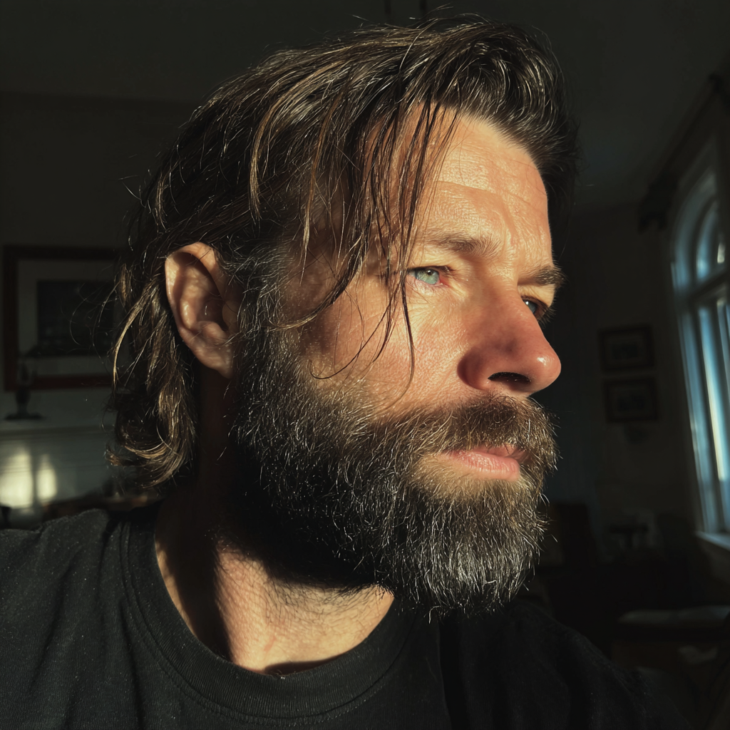 A pensive man wearing a black T-shirt | Source: Midjourney