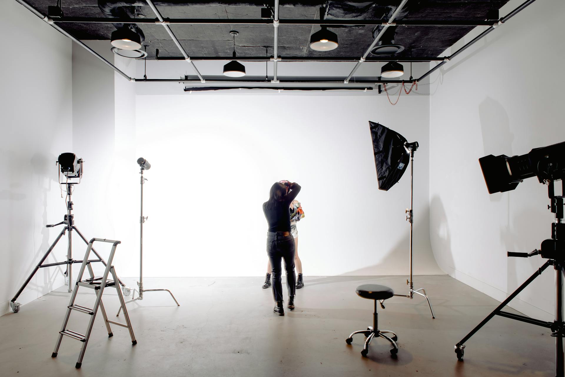A professional photographer during a photo shoot in her studio | Source: Pexels