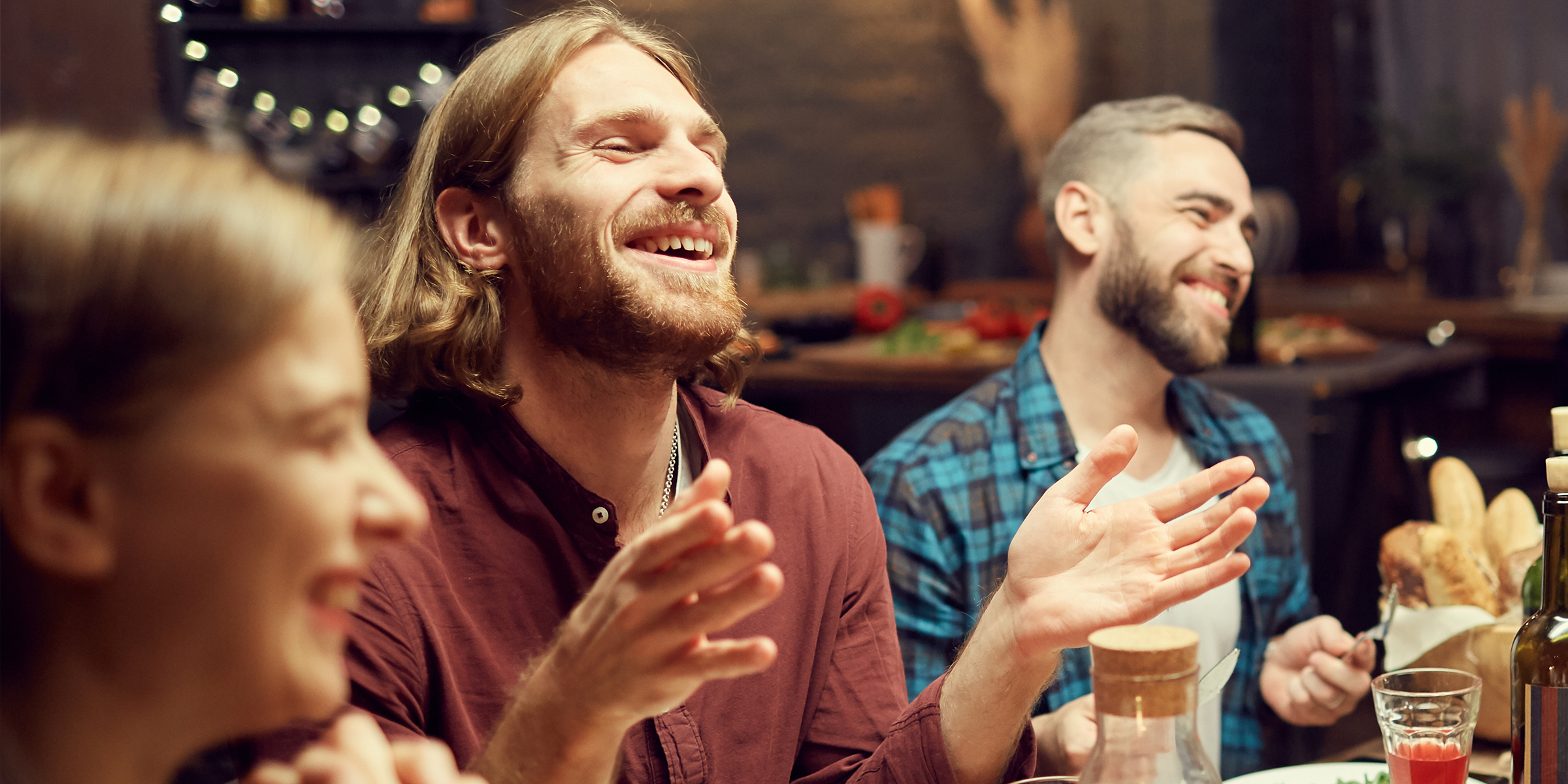 A man laughing with his friends | Source: Shutterstock