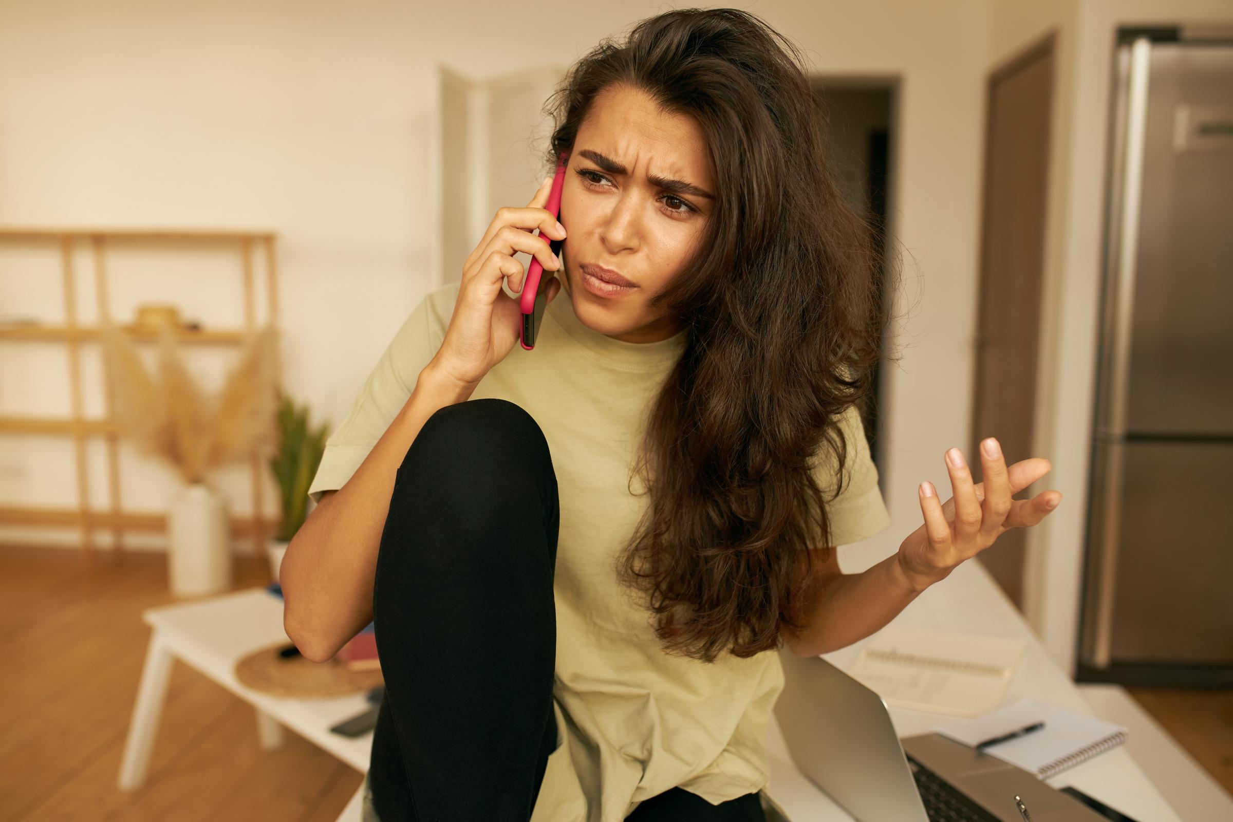 An upset woman on a call | Source: Freepik