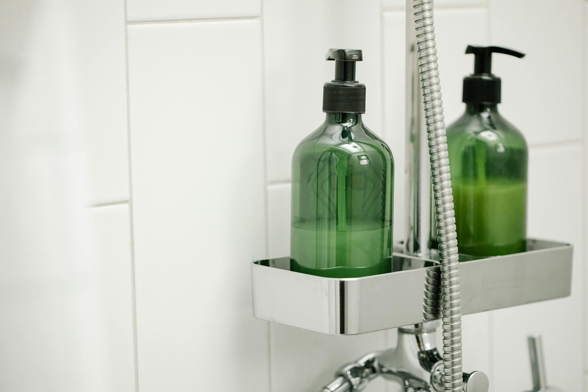 Green dispensers in a bathroom | Source: Pexels