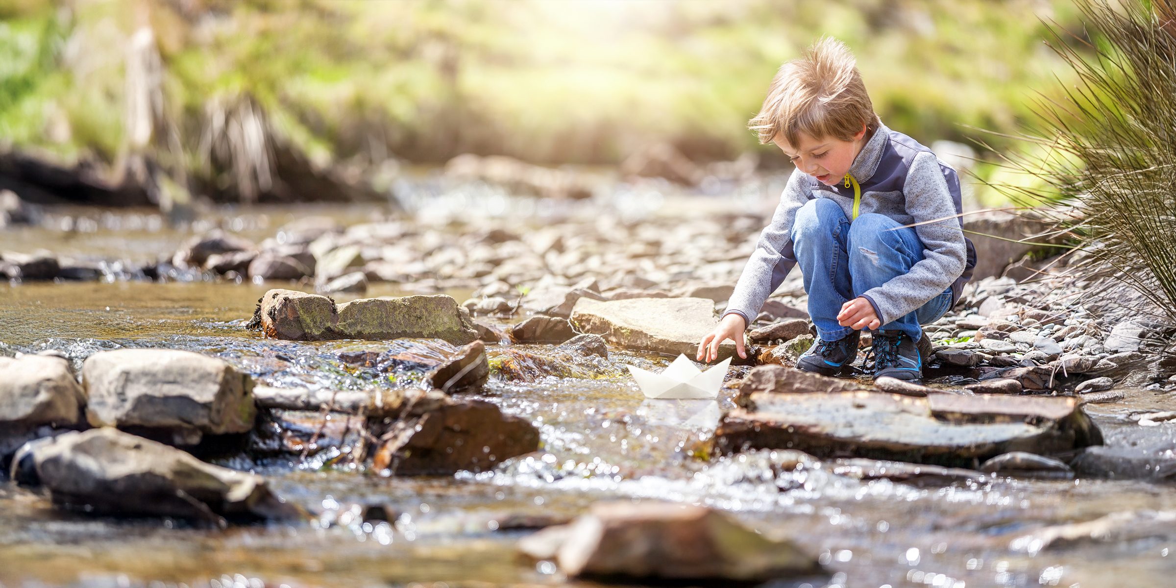 A child playing in a creek | Source: Shutterstock