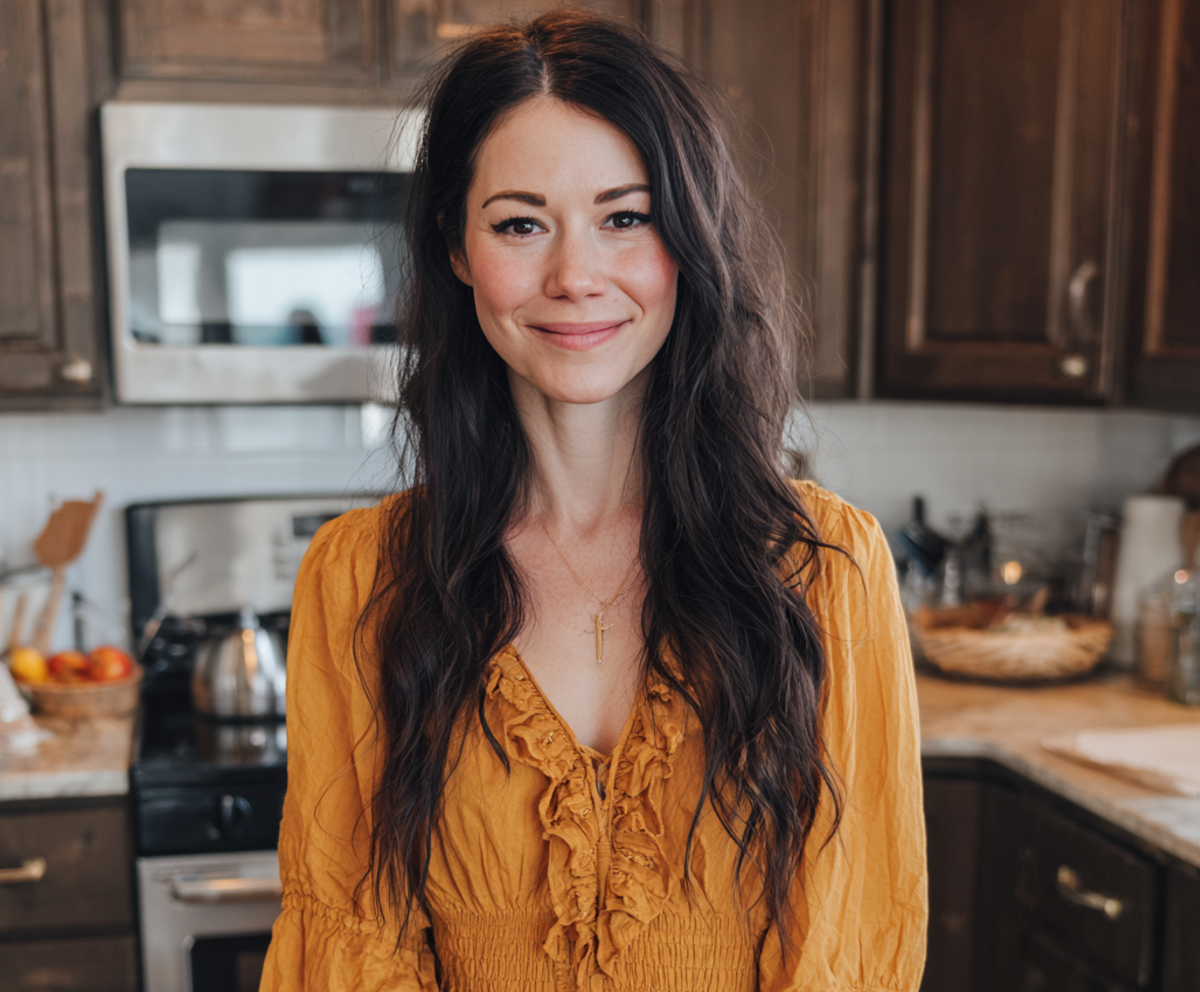A smiling woman standing in a kitchen | Source: Midjourney