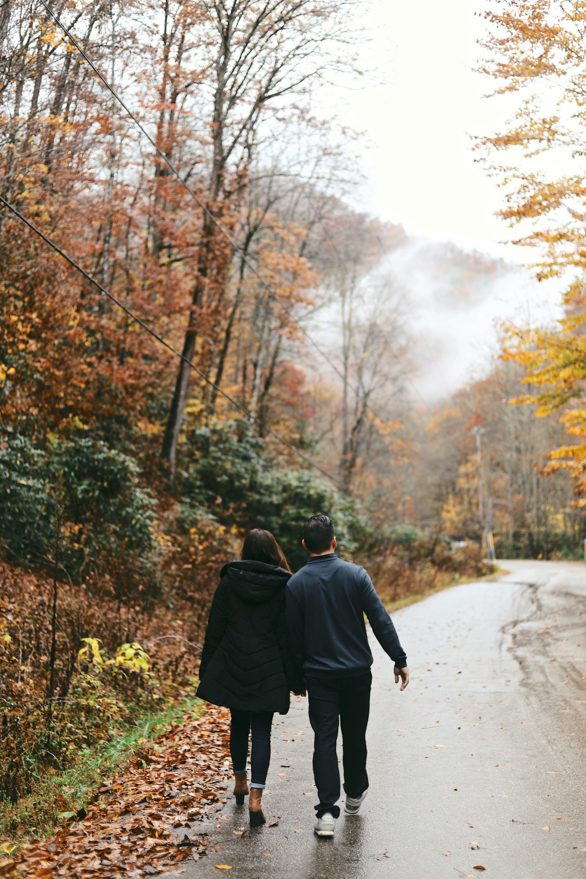 A couple holding hands and walking on the road | Source: Unsplash