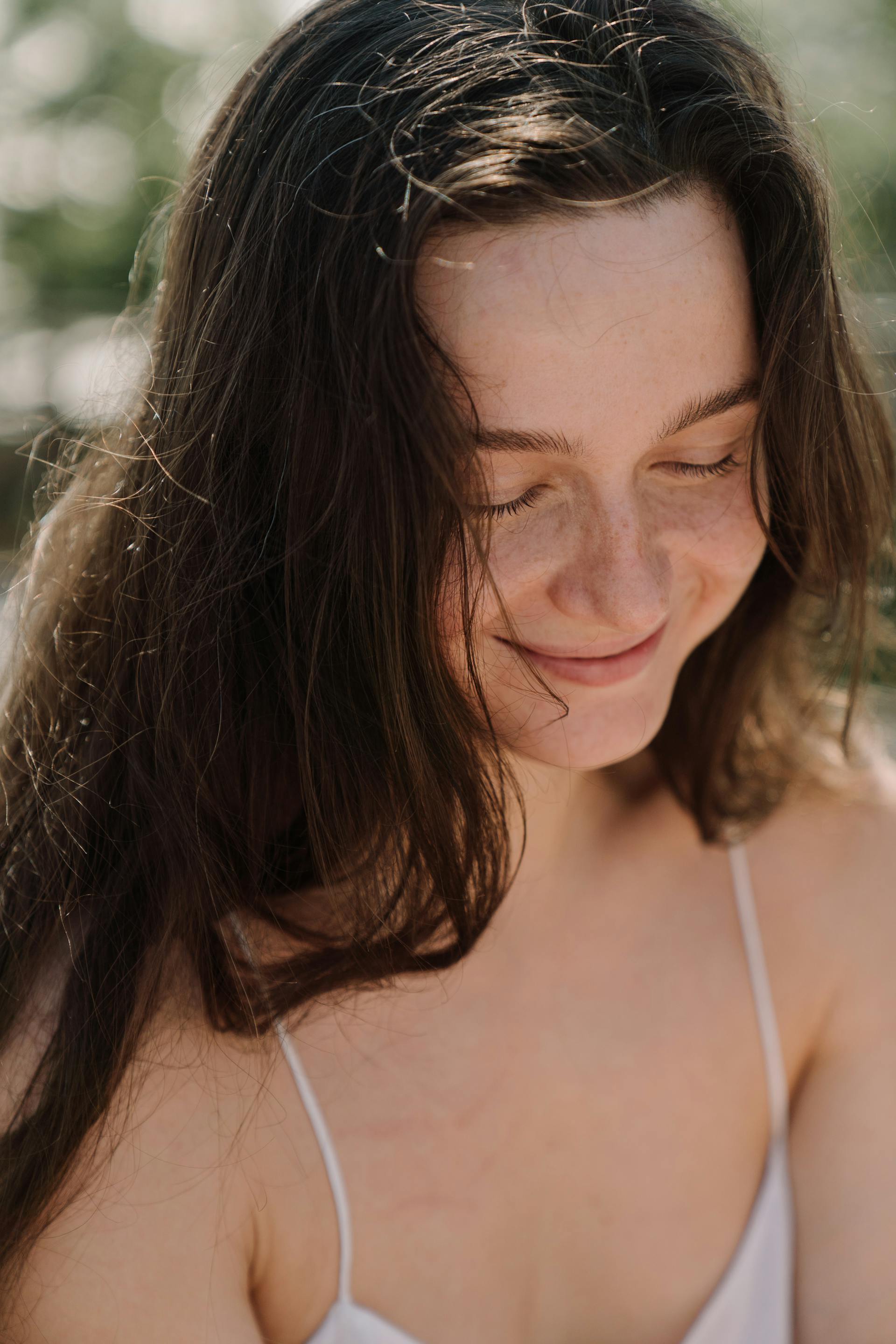 A woman smiling shyly | Source: Pexels