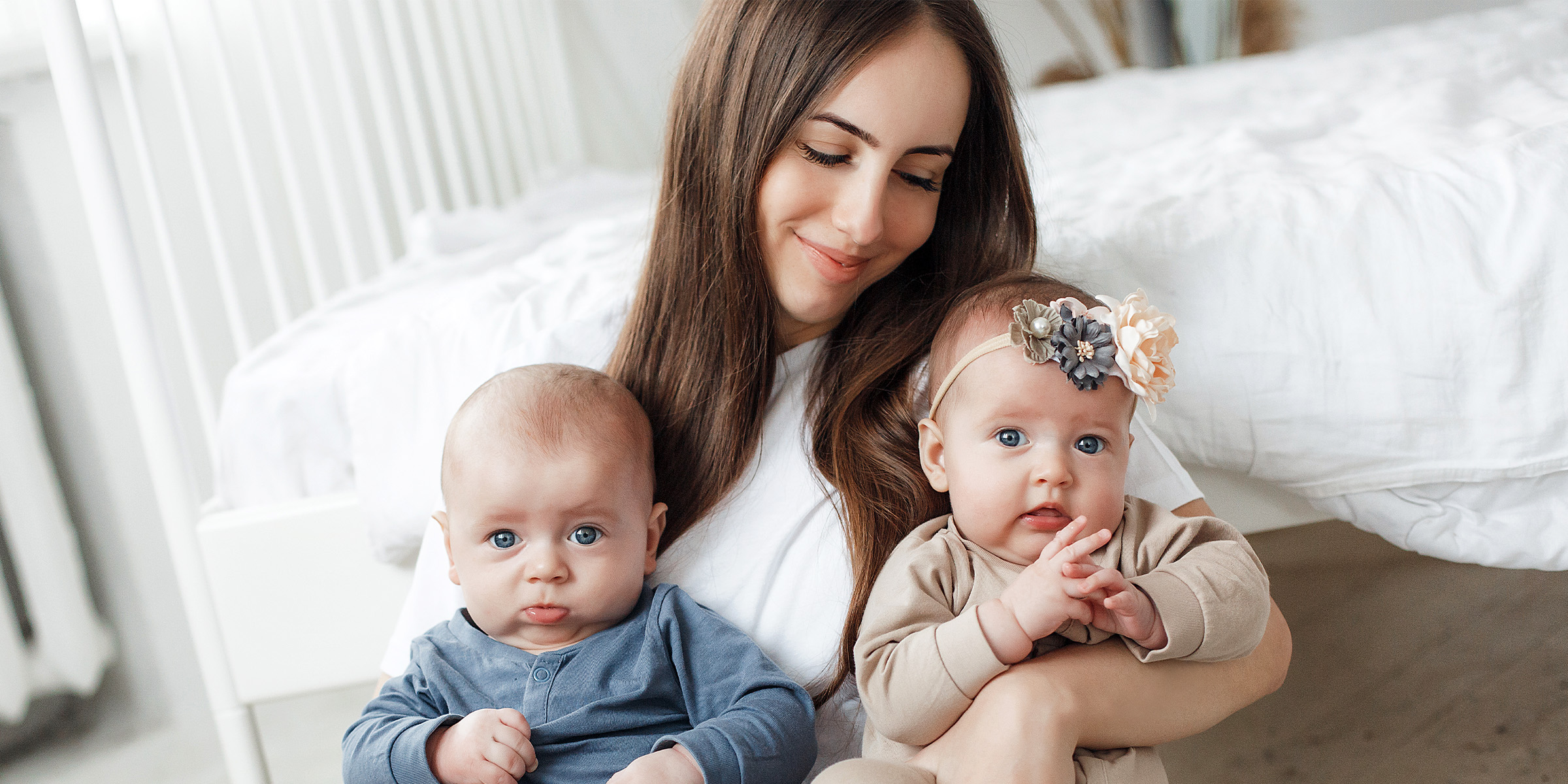 A woman holding her babies | Source: Freepik