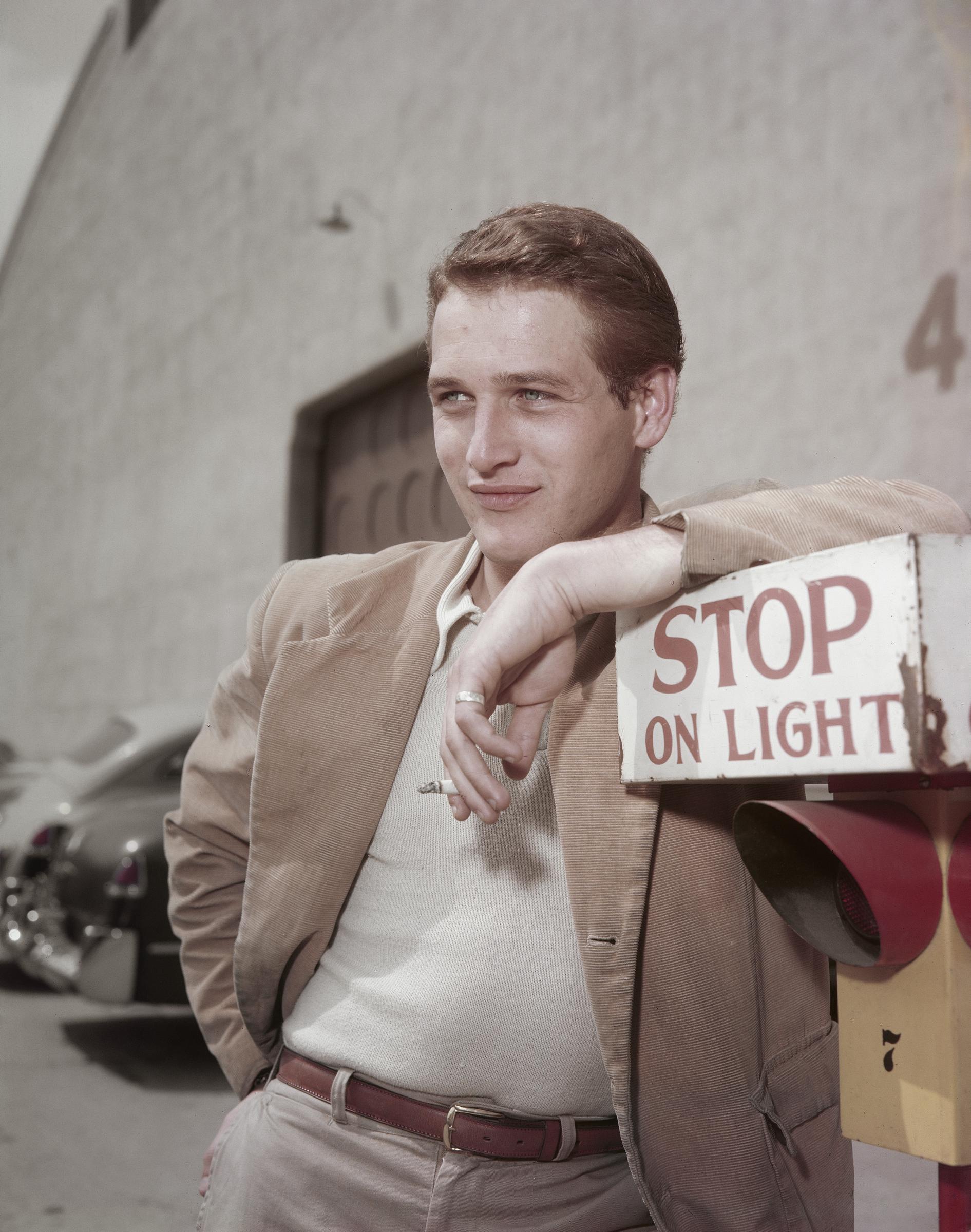 Paul Newman leaning on a sign during filming of "The Silver Chalice," circa 1954 | Source: Getty Images