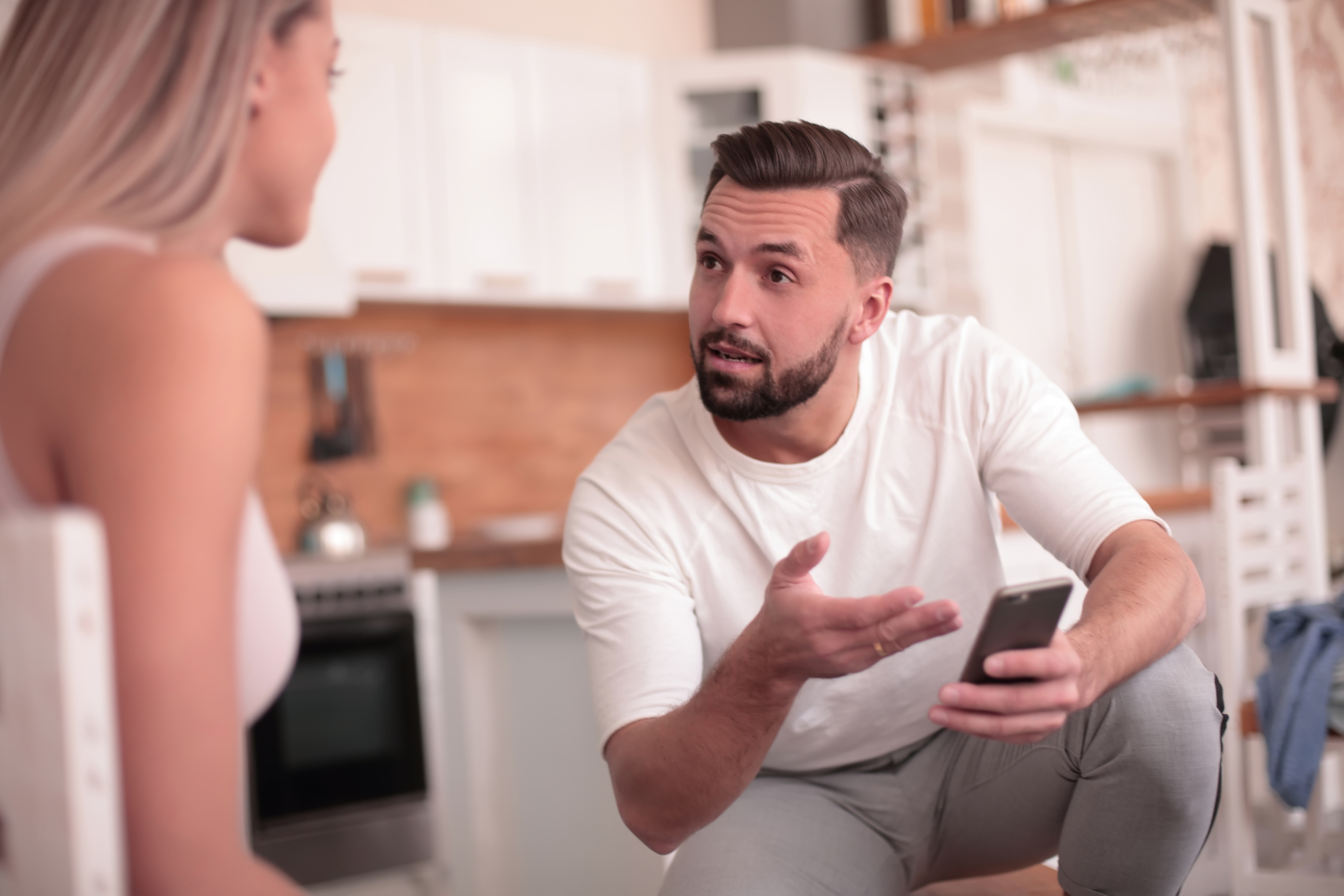 A young man explaining something to his wife | Source: Shutterstock