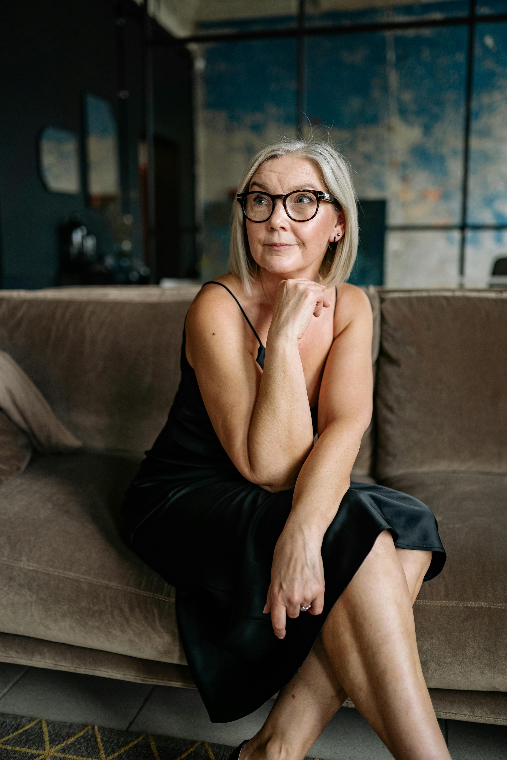 A senior woman sitting on the sofa | Source: Pexels