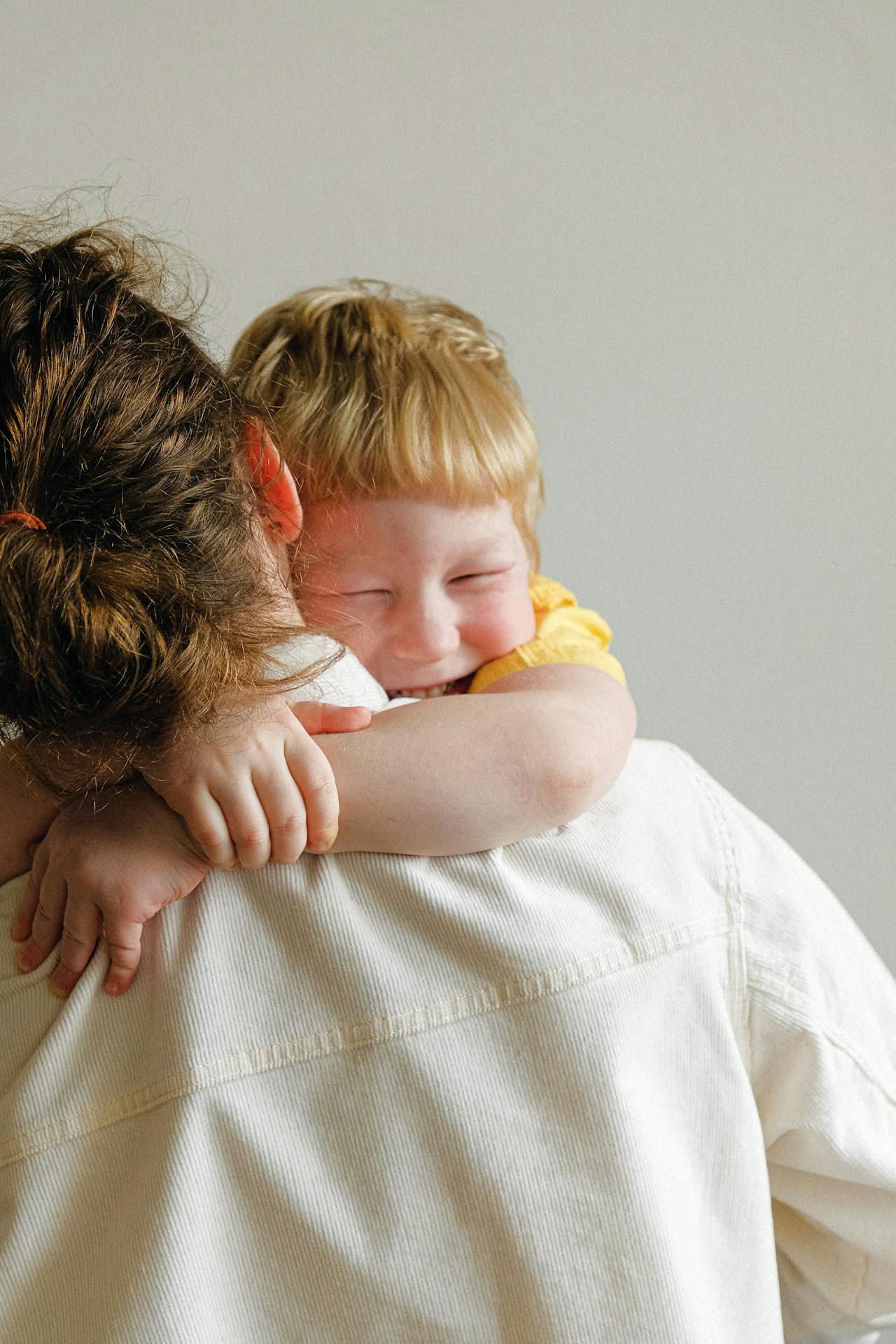 A little boy hugging his mother | Source: Pexels